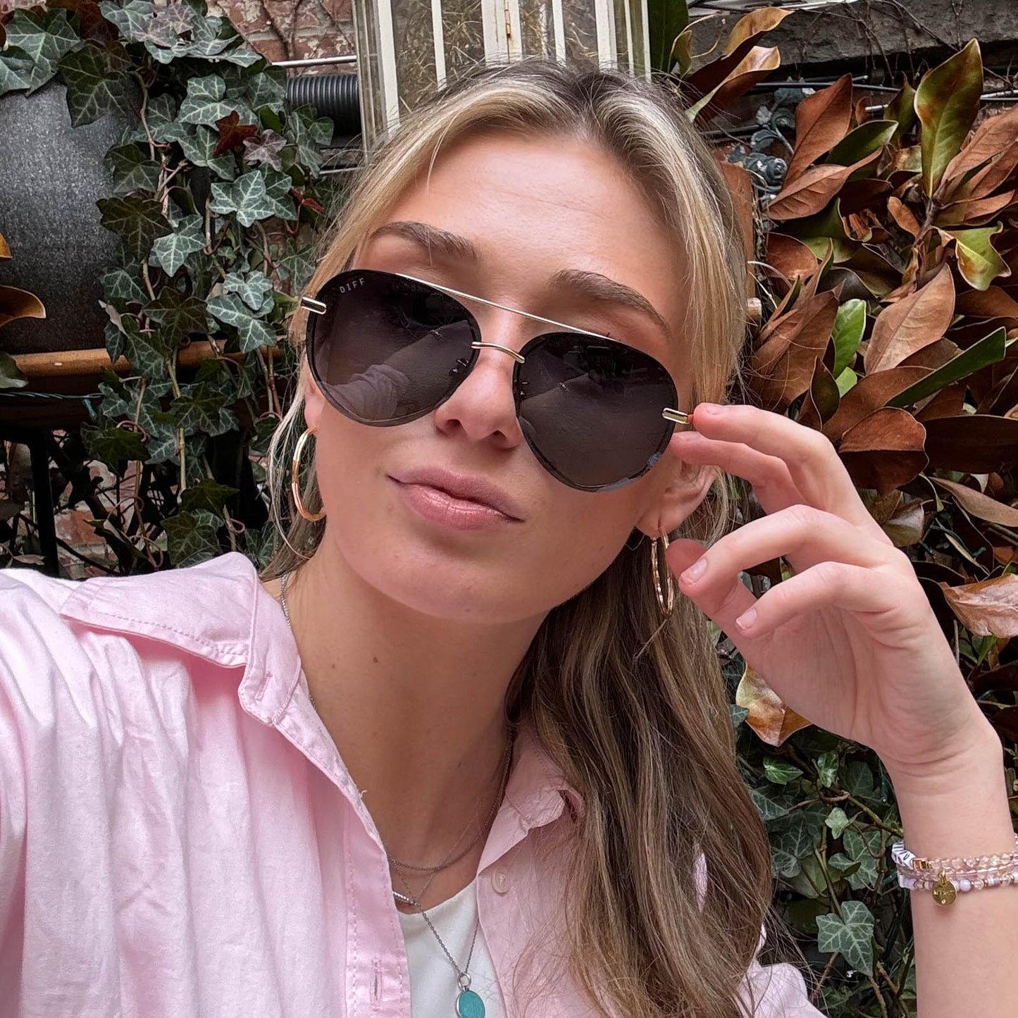 customer content - female wearing lenox gold and black and grey gradient polarized front