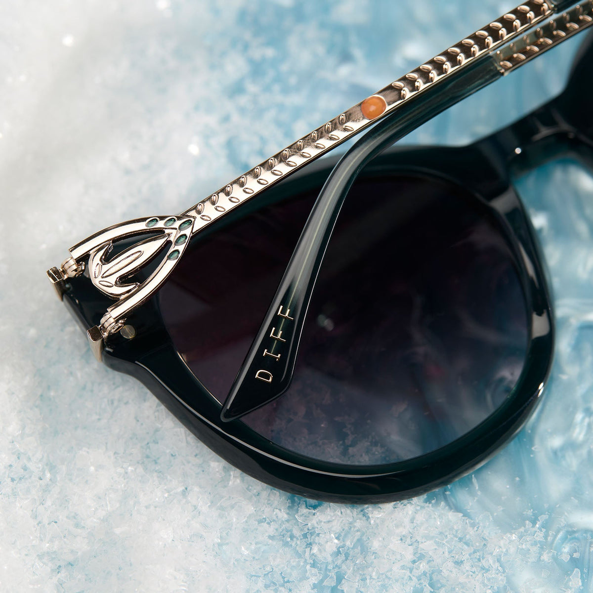 frozen x diff eyewear featuring the anna cat eye sunglasses with a rich emerald frame and royal purple gradient lenses detailed temple view