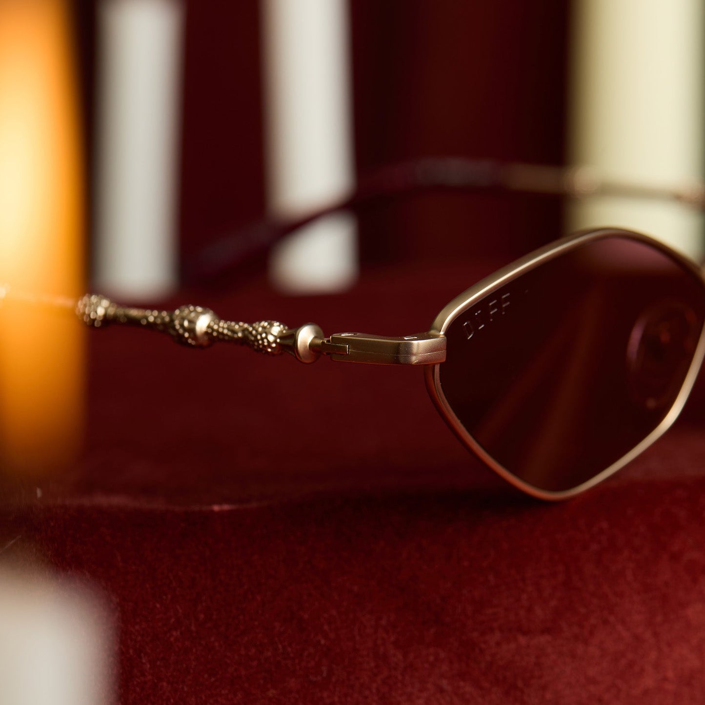 lifestyle - harry potter x diff eyewear featuring professor dumbledore sunglasses with a gold frame and aubergine lenses detailed view