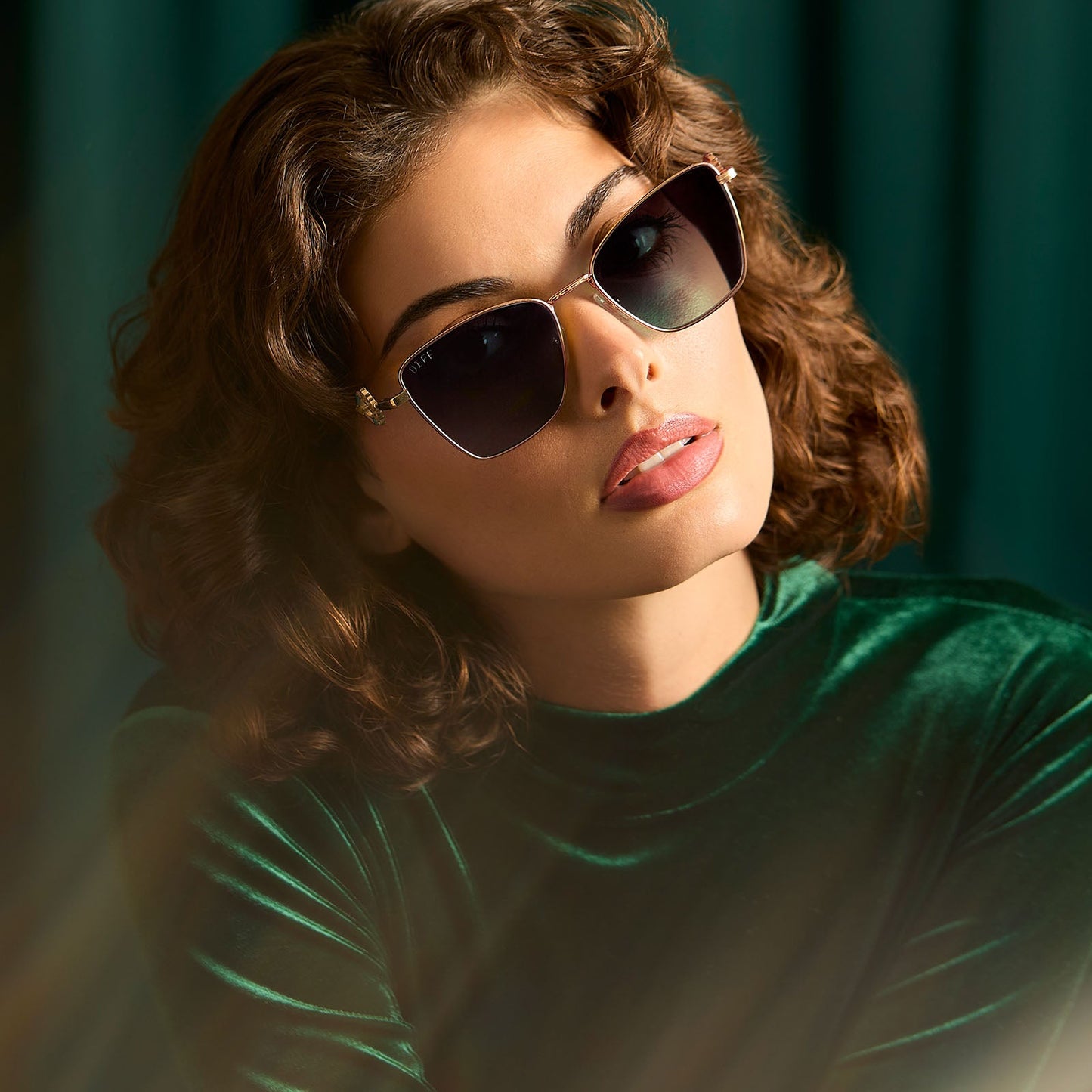 lifestyle - female wearing harry potter x diff eyewear featuring professor mcgonagall cat eye sunglasses with a gold frame and g15 lenses front view
