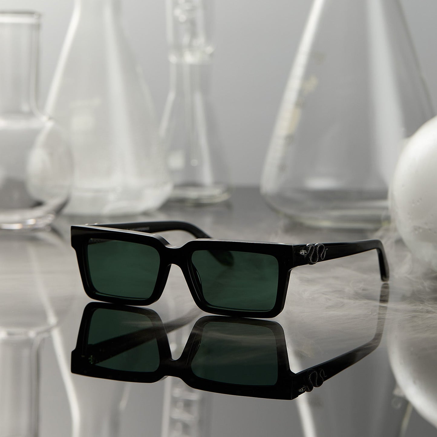 lifestyle - surrounded by potion flask harry potter x diff eyewear featuring professor snape 2.0 square sunglasses with a black frame and g15 lenses front view