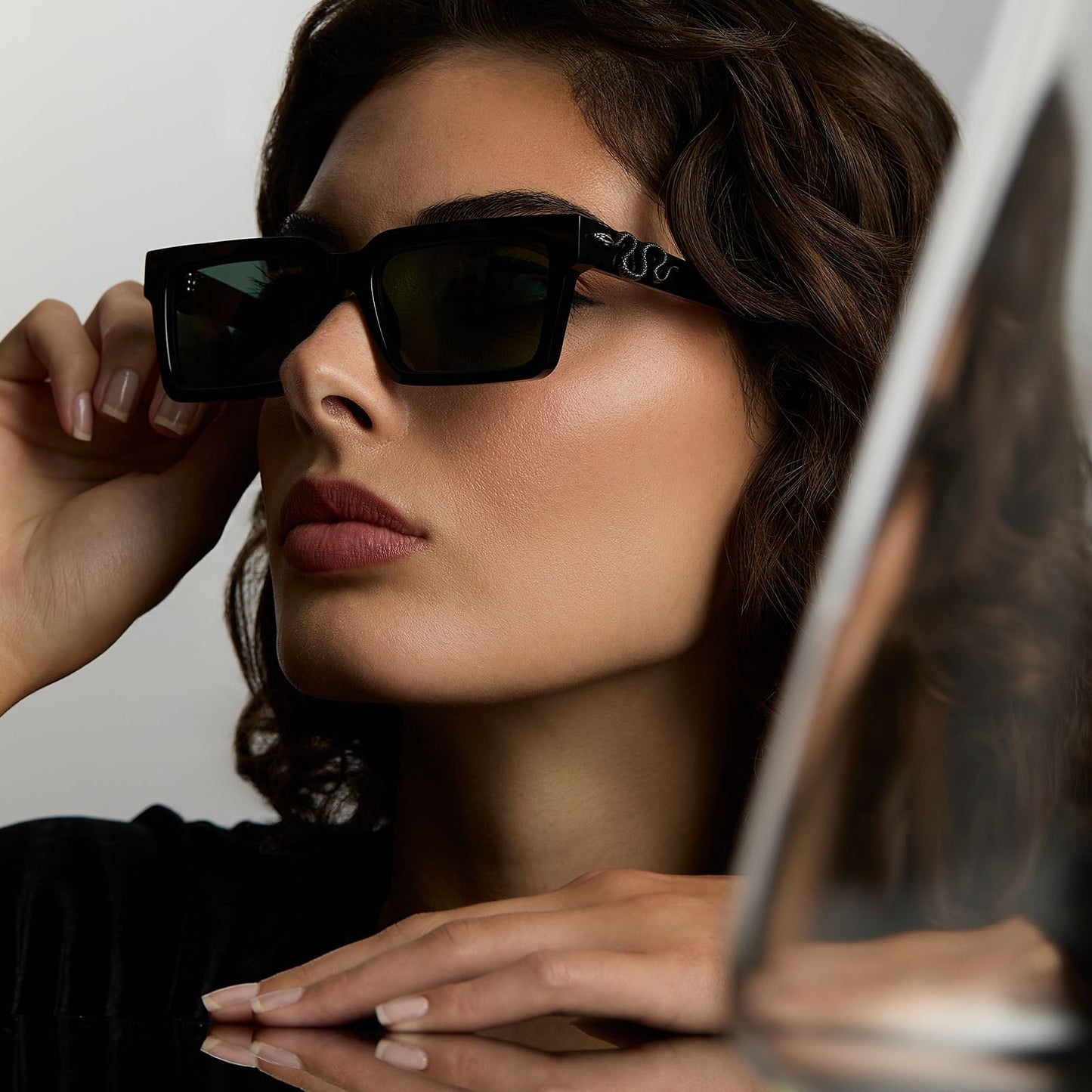 lifestyle - female wearing harry potter x diff eyewear featuring professor snape 2.0 square sunglasses with a black frame and g15 lenses angled view