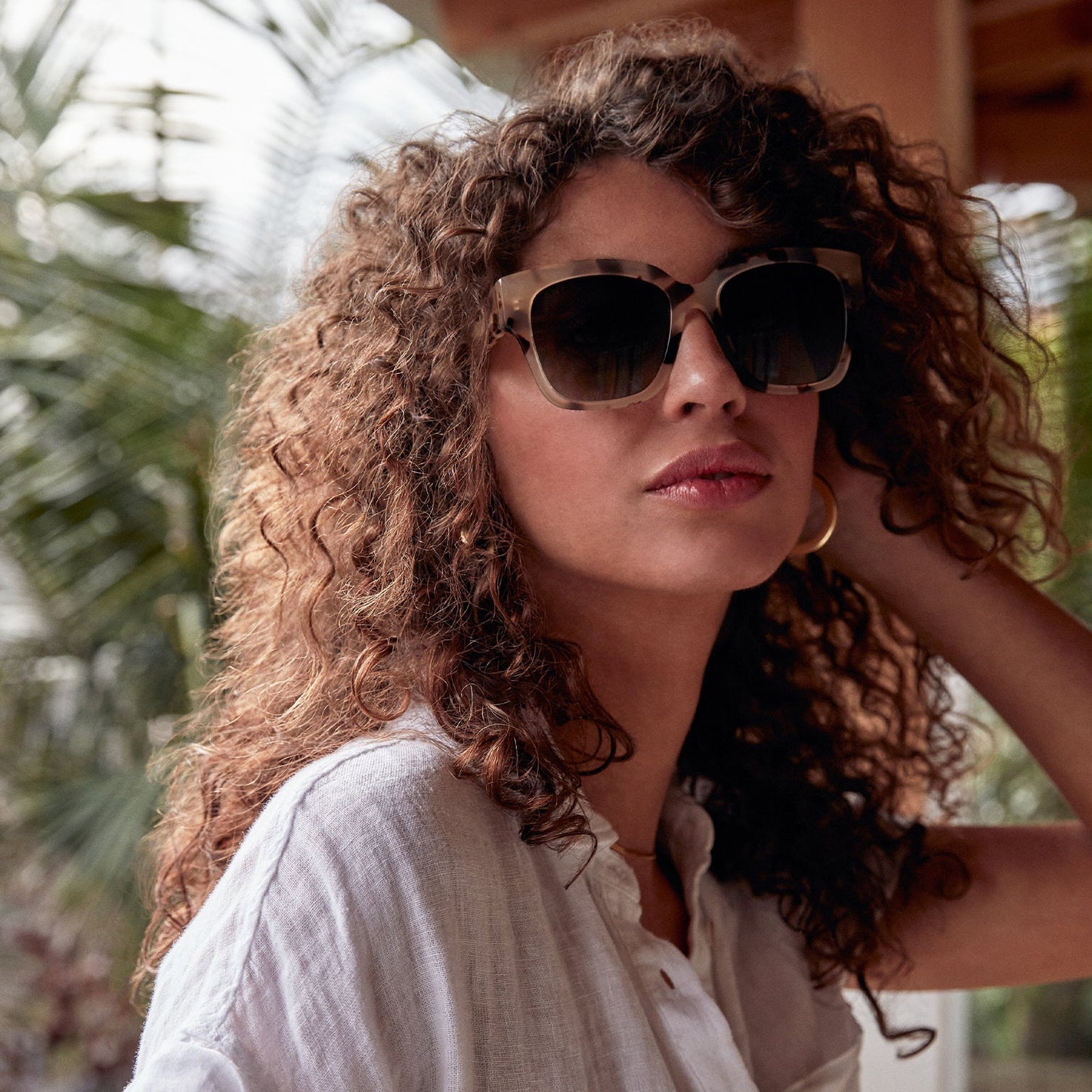lifestyle - brunette wearing bella ii cream tortoise grey gradient sunglasses