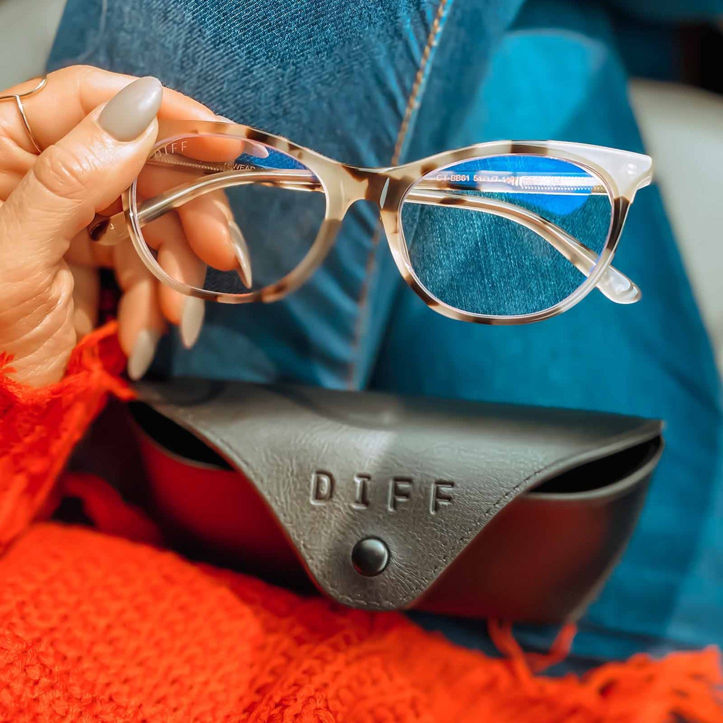influencer holding the jade in cream tortoise and blue light