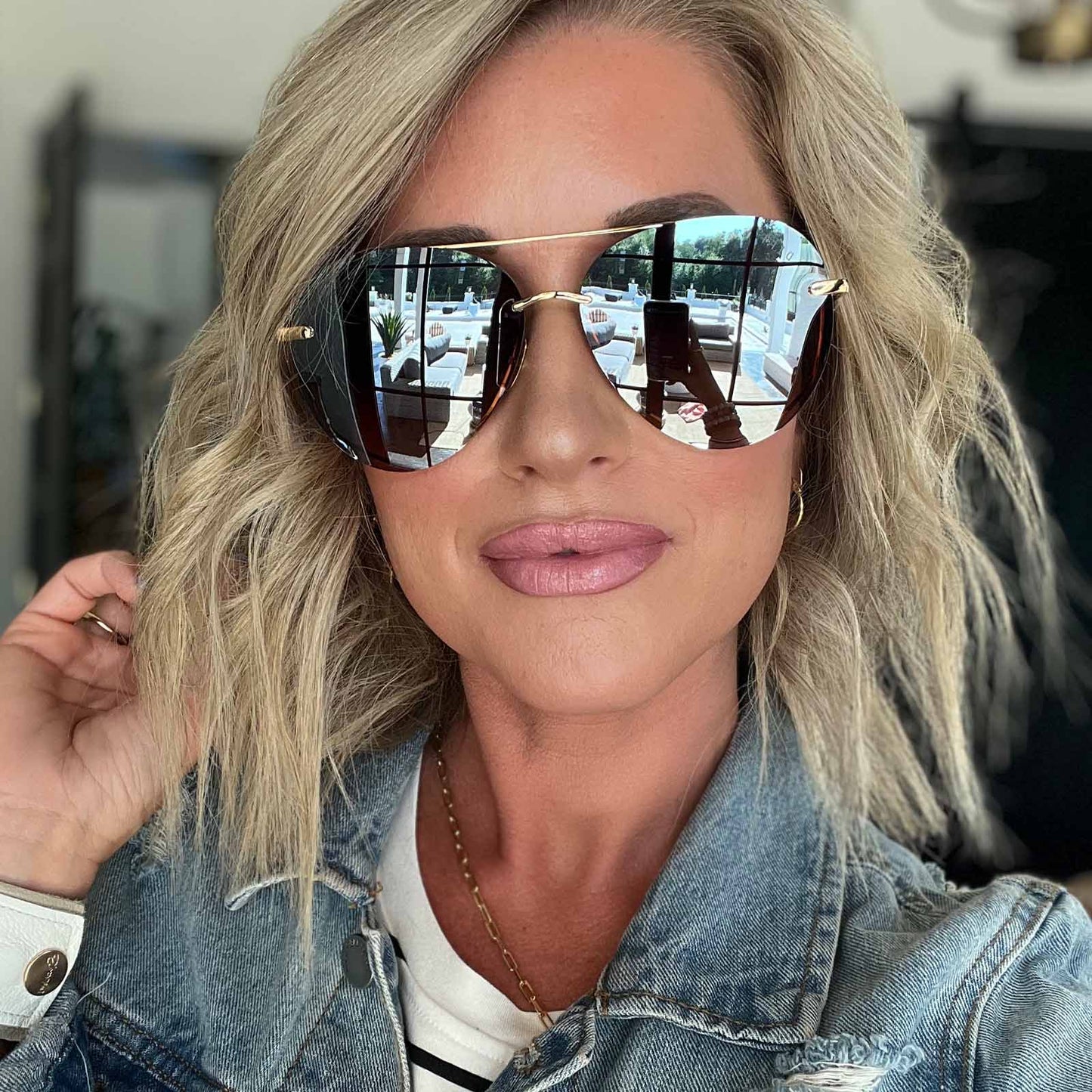 lifestyle - female wearing diff eyewear lenox aviator sunglasses with a gold frame and brown gradient mirror polarized lenses