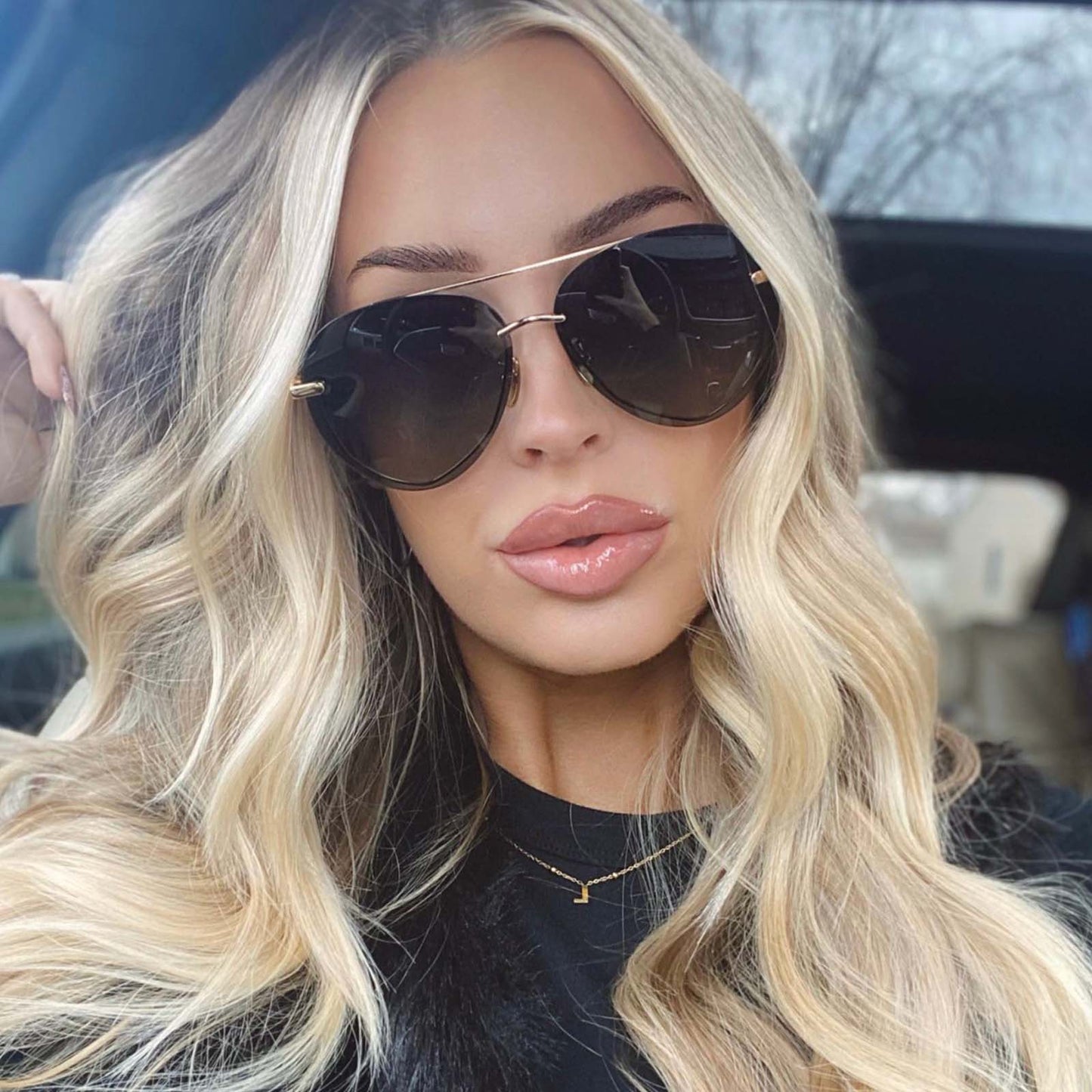 lifestyle - blonde female wearing lenox aviator sunglasses with a gold/black metal frame and grey gradient polarized lenses