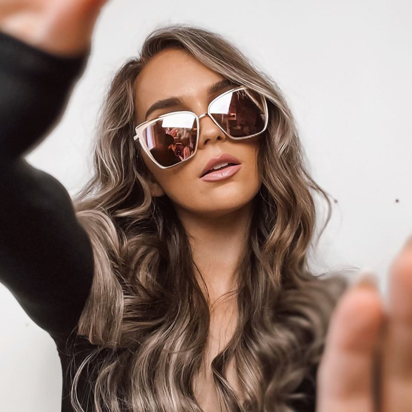 lifestyle - female wearing becky gold metal frame and flash brown gradient lenses