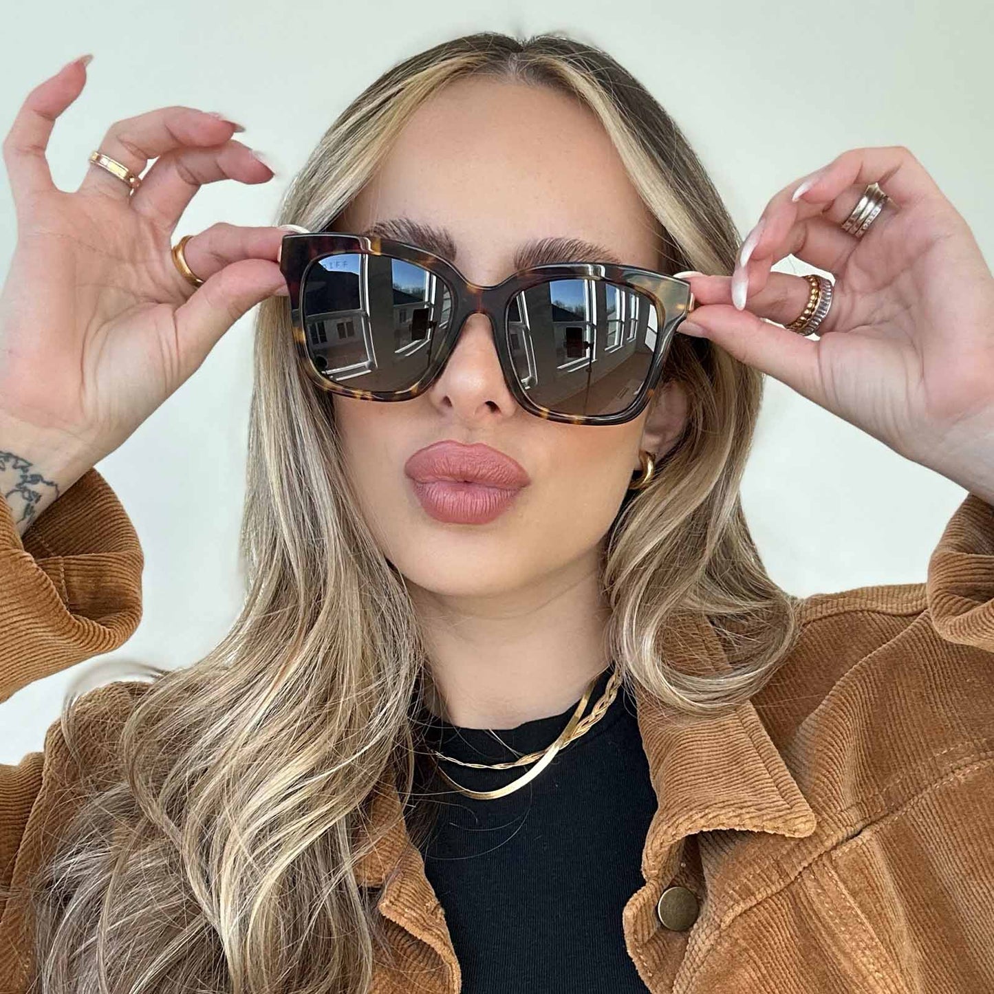 lifestyle - blonde female wearing bella amber tortoise and steel gradient