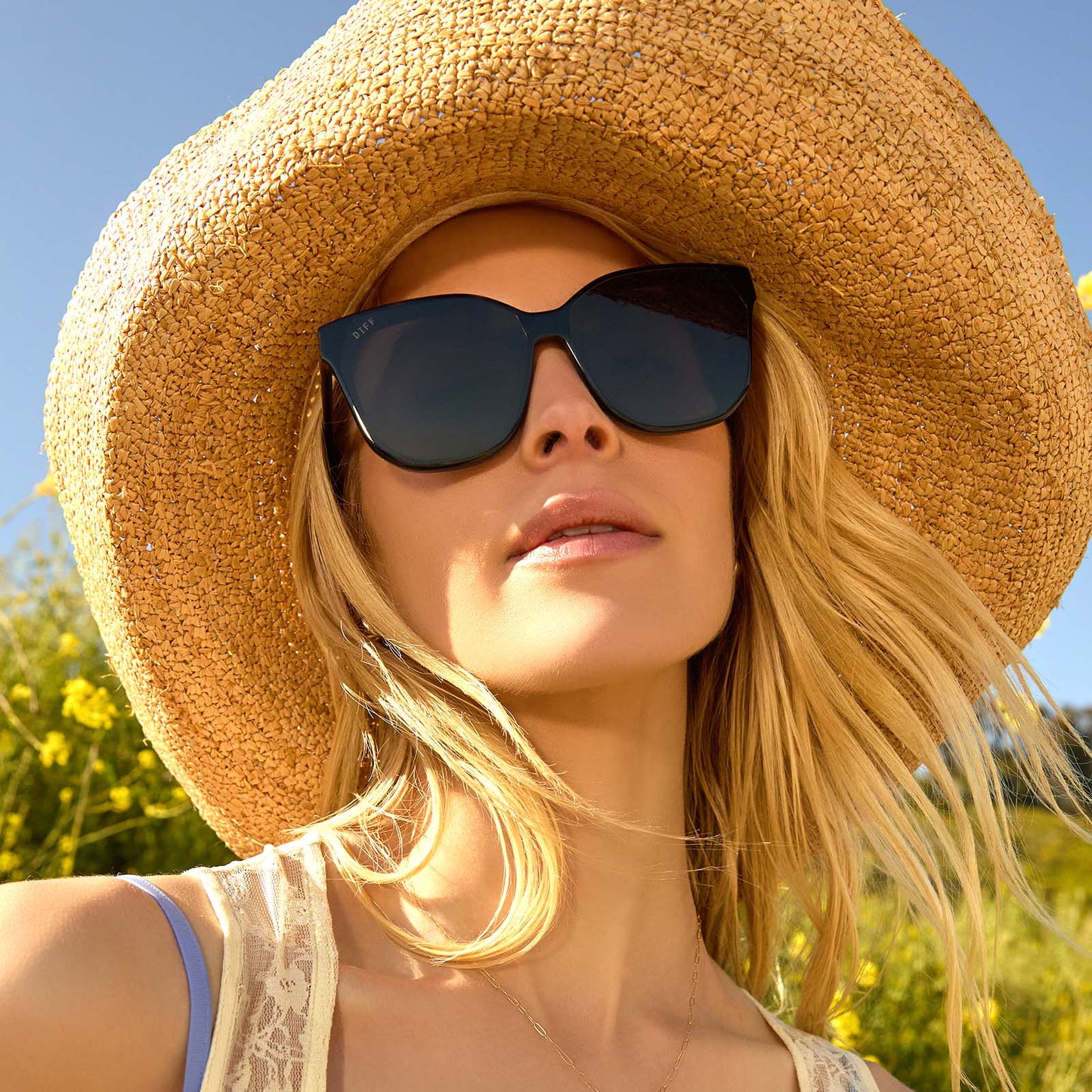 on model - female wearing Gia Black and Grey Oversized Cat Eye Sunglasses with large hat