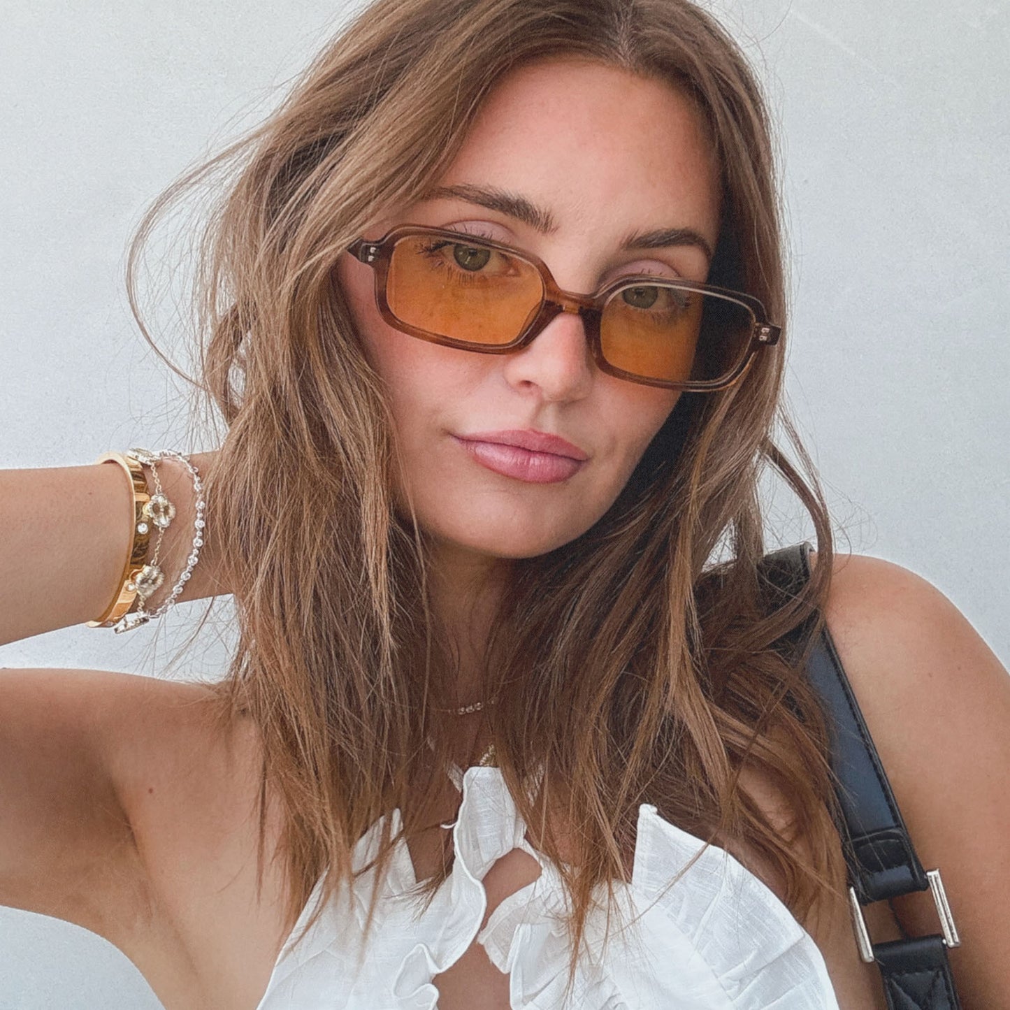 lifestyle - aspyn ovard x diff eyewear female wearing the elle rectangle sunglasses with a tortoise frame and brown tint lenses front view