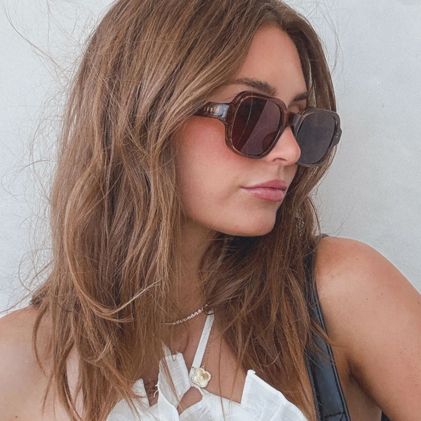 on model - female wearing aspyn ovard x diff eyewear featuring the lola square prescription sunglasses with a tortoise frame side view