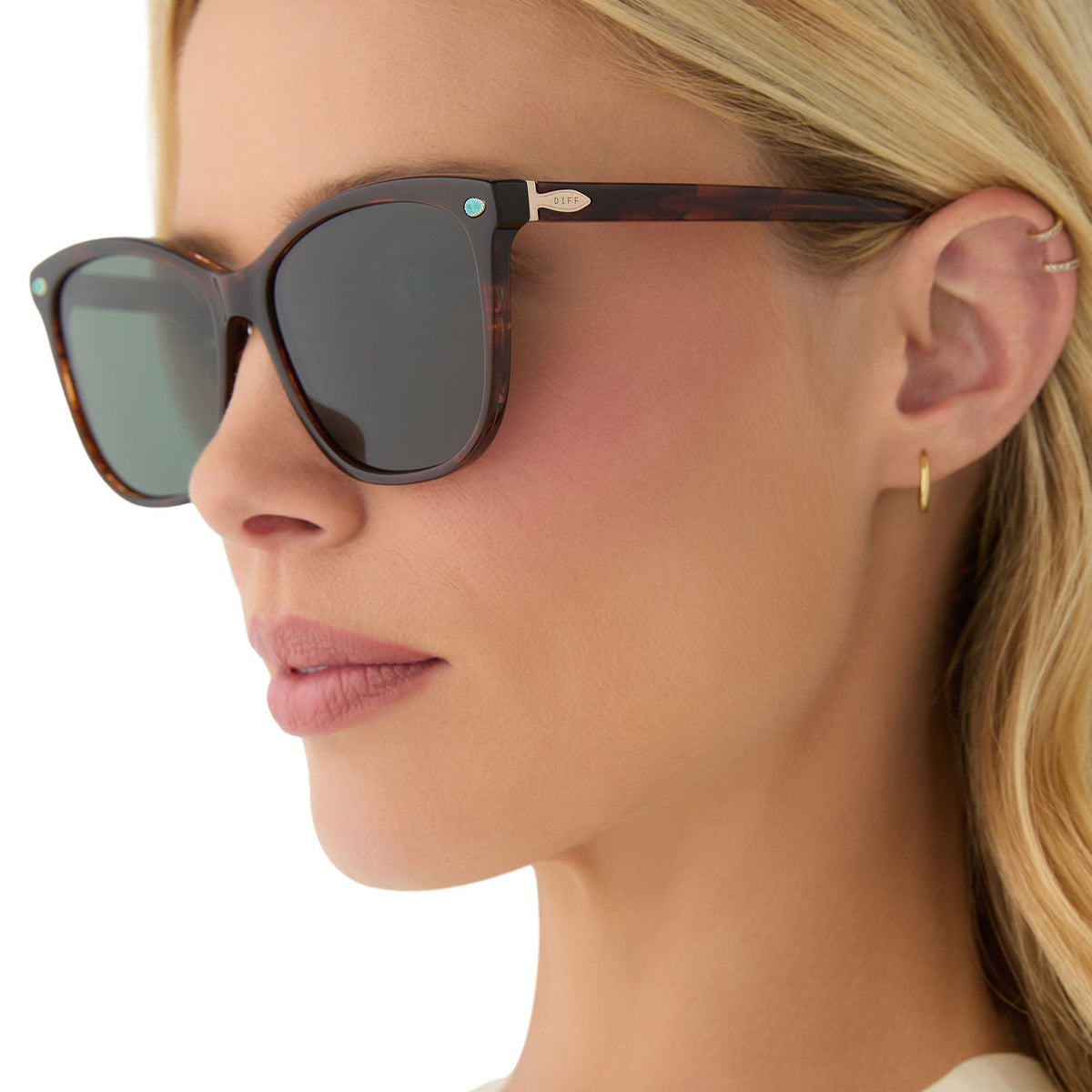 on model - female wearing yellowstone x diff eyewear featuring the beth iii cat eye sunglasses with a sequoia tortoise frame and g15 polarized lenses side view