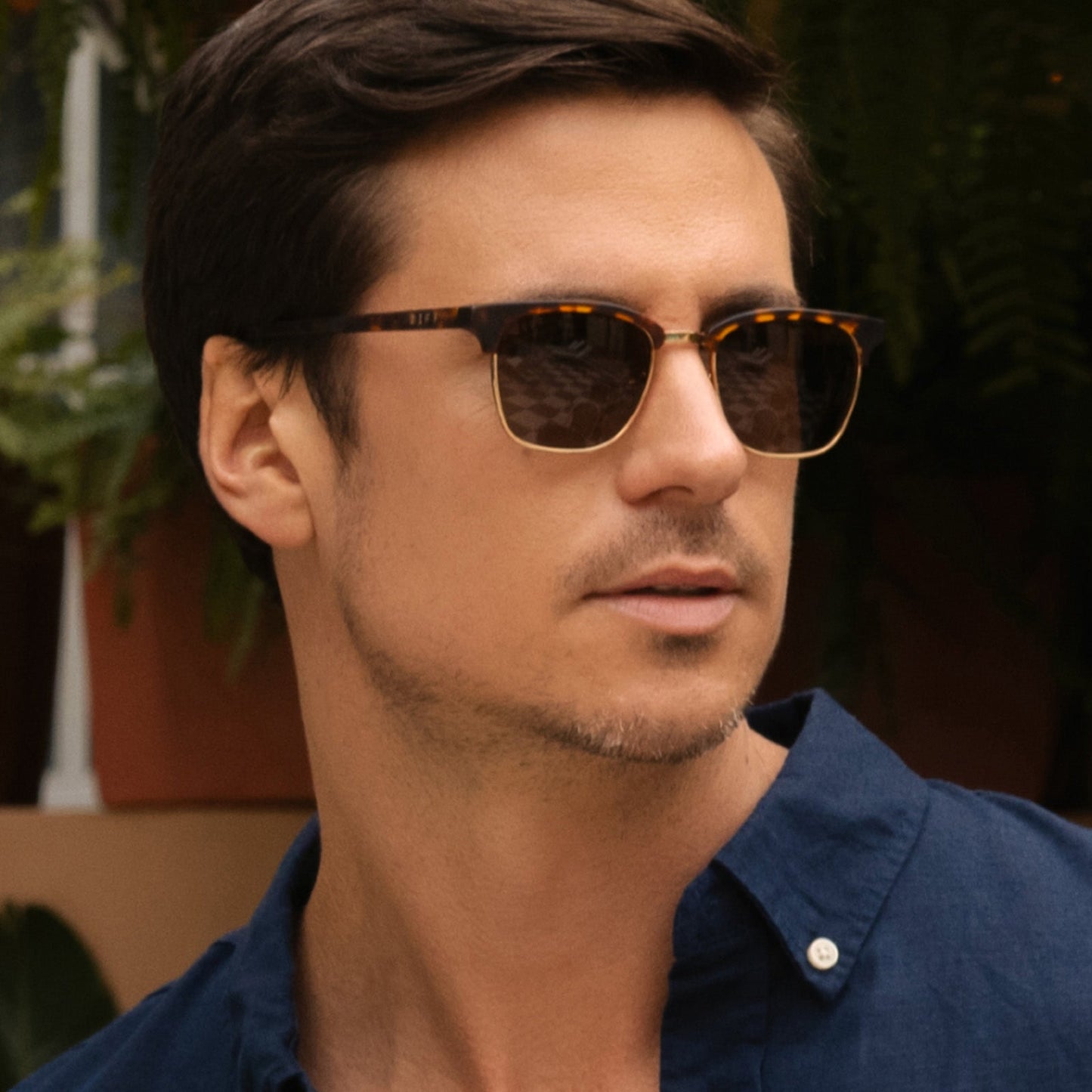 lifestyle - male wearing diff eyewear biarritz square sunglasses with a rich tortoise/gold frame and brown polarized lenses angled view