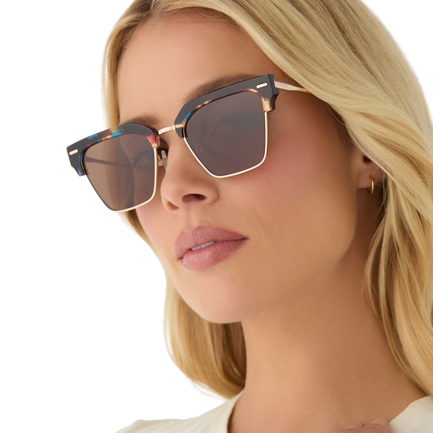 on model - female wearing diff eyewear featuring the capri rectangle sunglasses with a confetti tortoise frame and brown lenses angled view