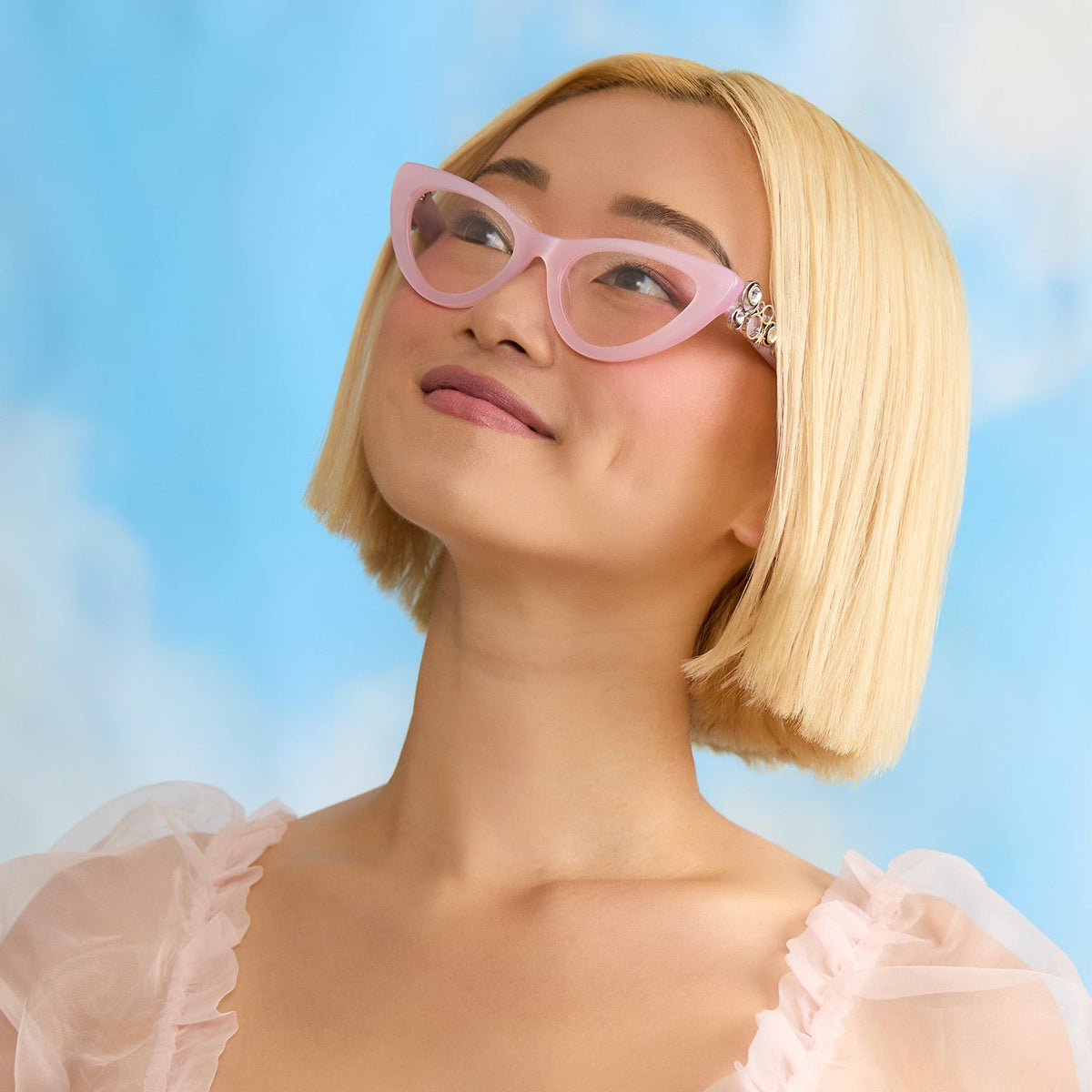 on model - female wearing wicked x diff eyewear featuring the glinda upland for good cat eye prescription glasses with a pink frame angled view