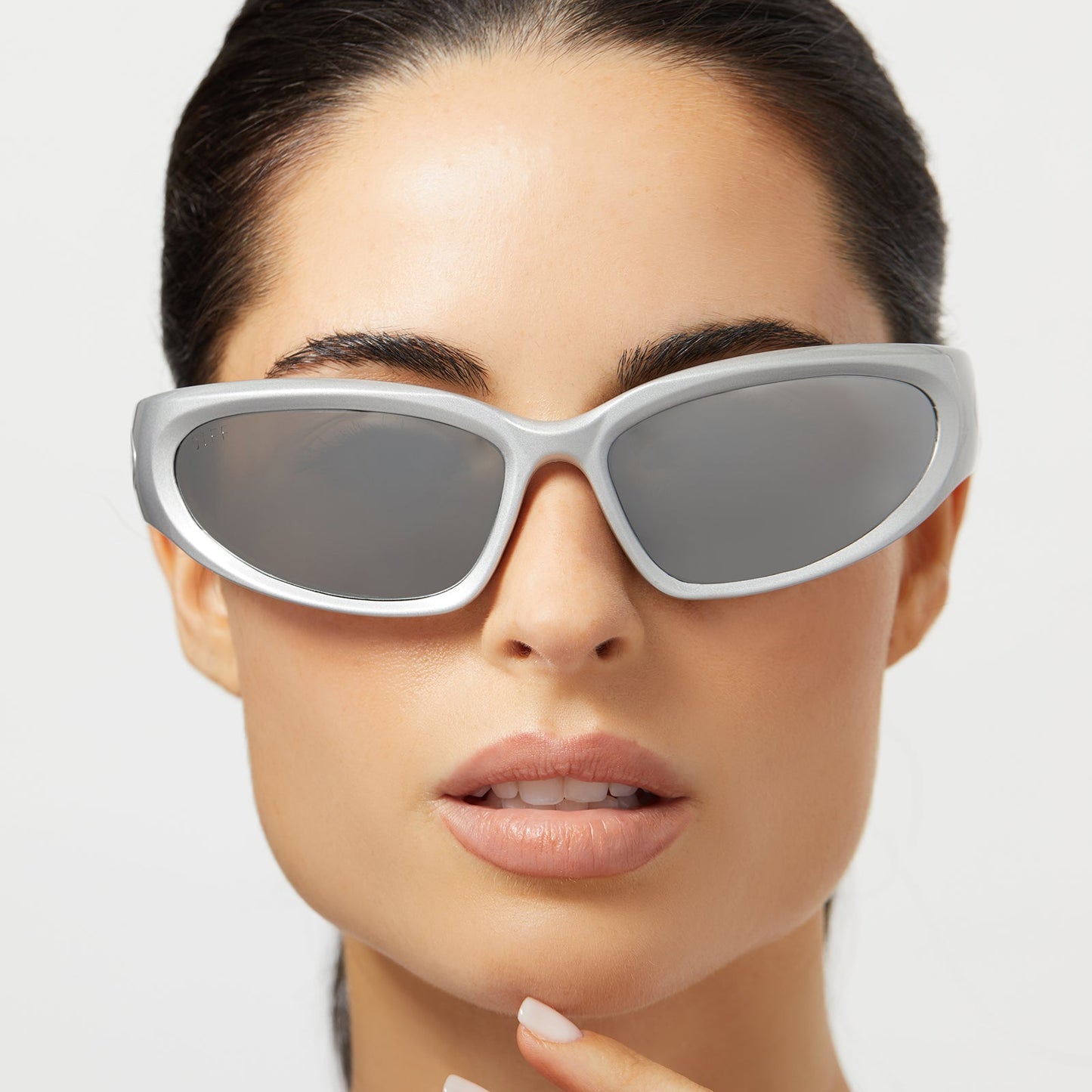 on model - female wearing diff sport side out wrap sunglasses with a silver frame and silver mirror polarized lenses front view