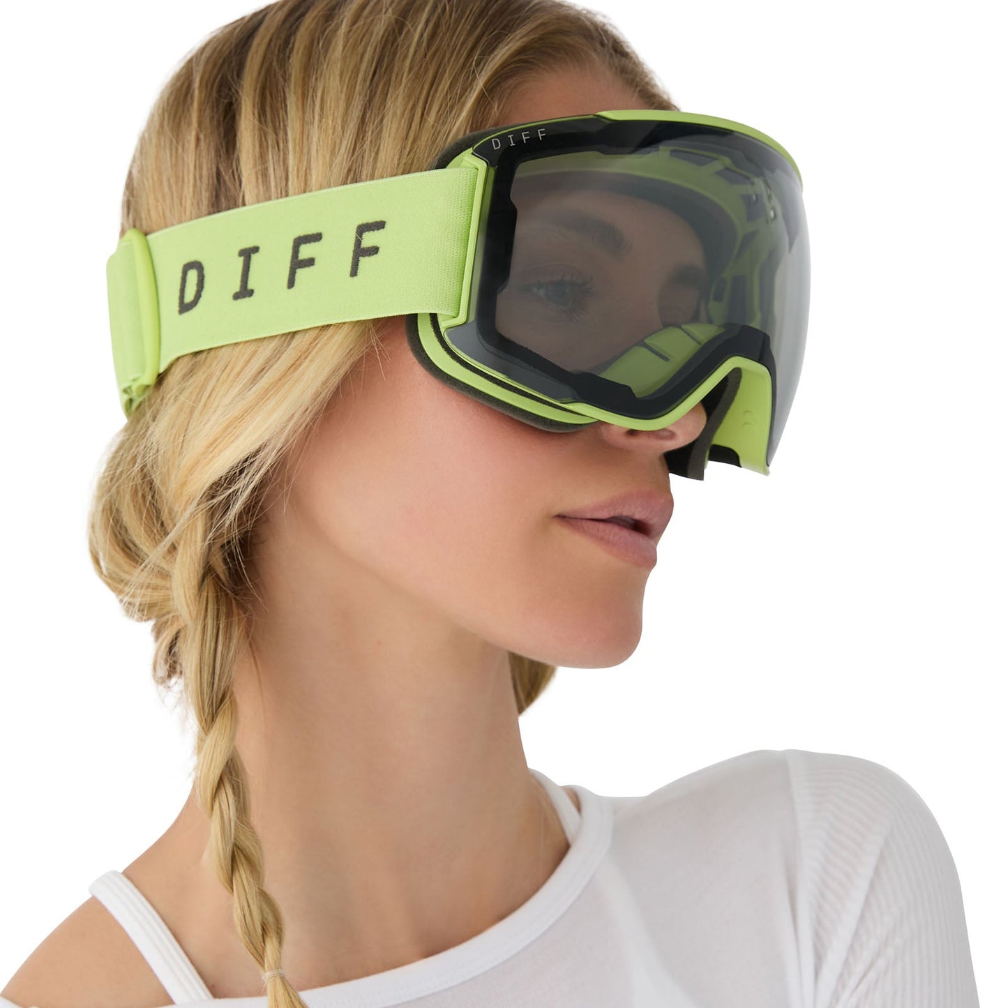 on model - female wearing diff sport alpine goggles in lime green with lowlight grey lens angled view