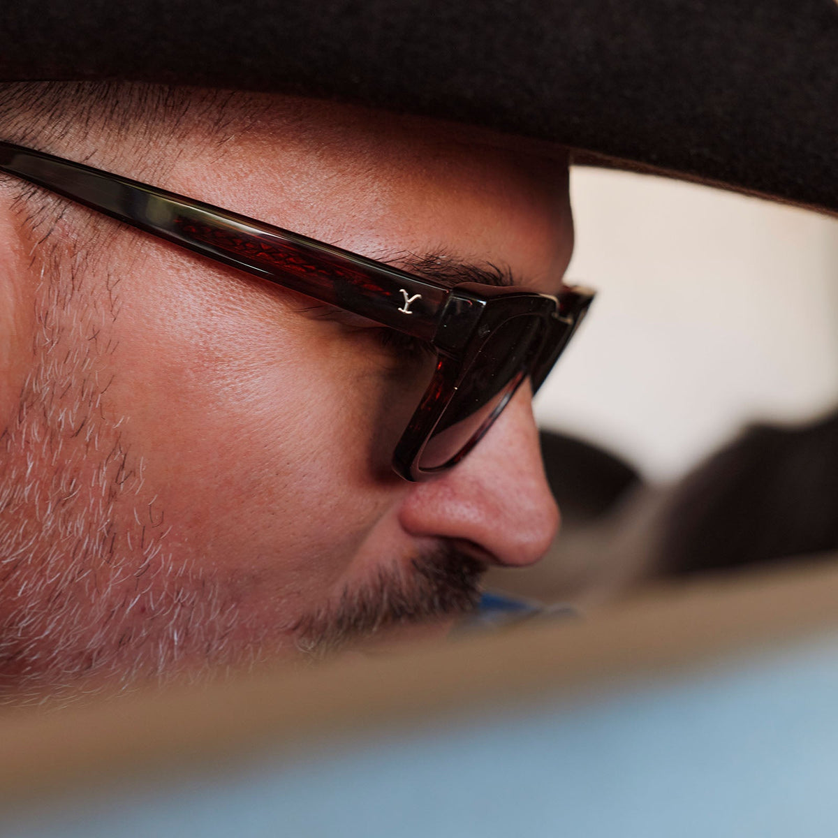 lifesytle - male cowboy wearing yellowstone x diff eyewear featuring the kayce dutton square sunglasses with a western sequoia acetate frame and green g15 polarized lenses detailed view