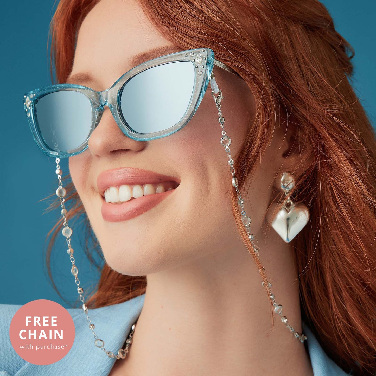 on model - female wearing disney princess x diff eyewear featuring the cinderella cateye sunglasses with a blue crystal glitter frame and blue dust gradient polarized lenses angled view and free chain with purchase
