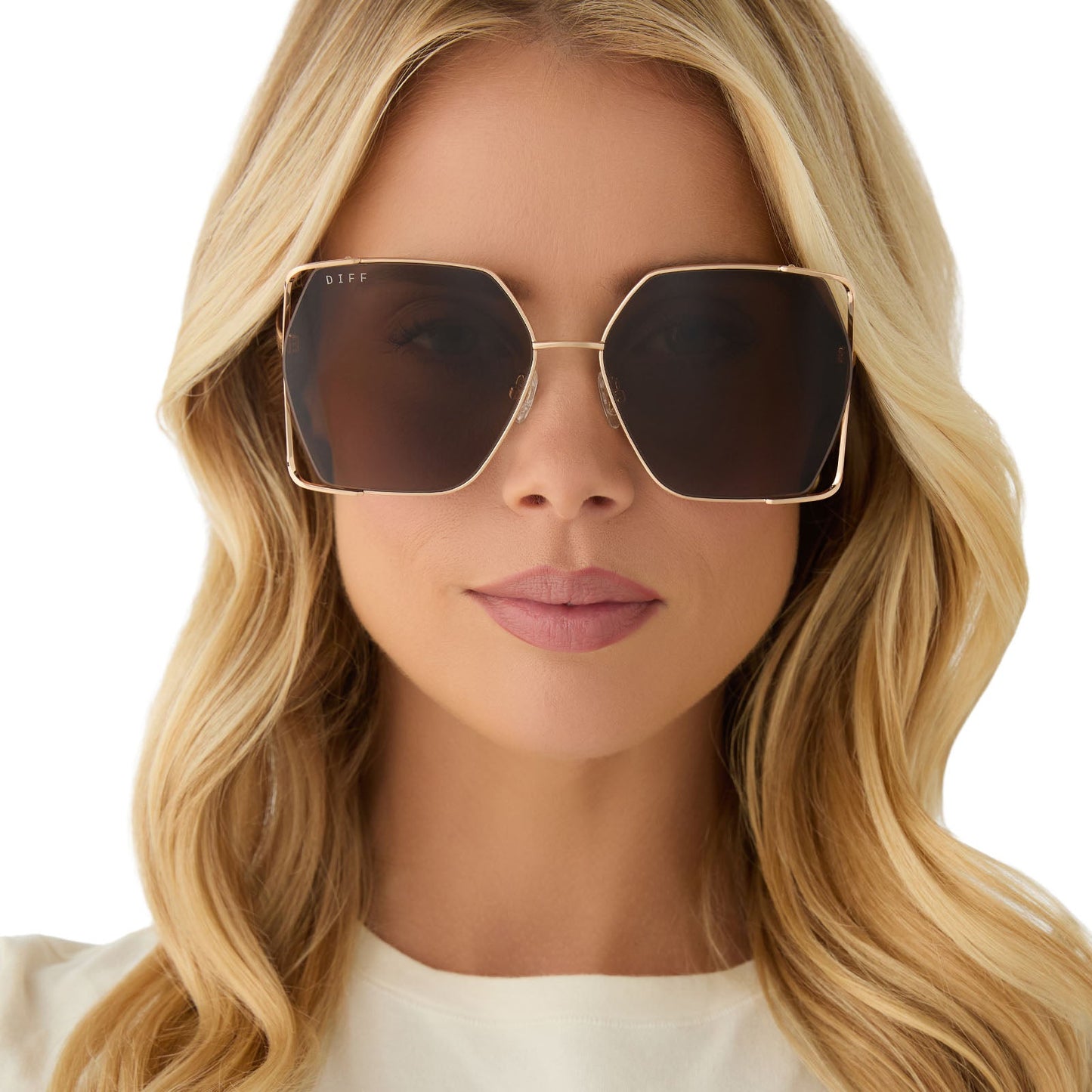 on model - female wearing diff eyewear featuring the donna iv square sunglasses with a brushed gold frame and truffle lenses front view