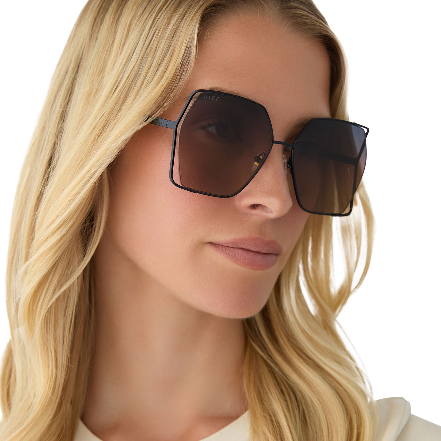 on model - female wearing diff eyewear featuring the donna iv square sunglasses with a black frame and twilight gradient polarized lenses angled view