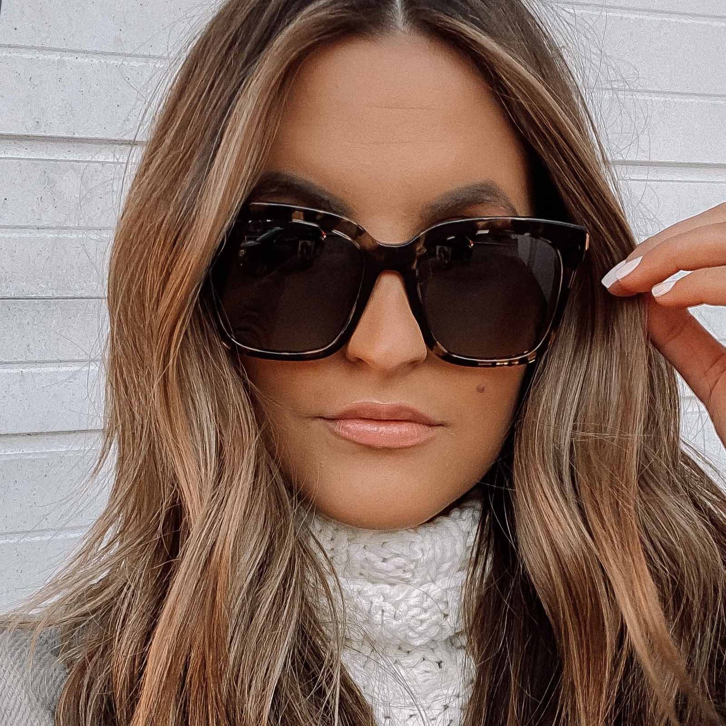 lifestyle - female wearing bella square sunglasses with a espresso tortoise acetate frame and grey lenses
