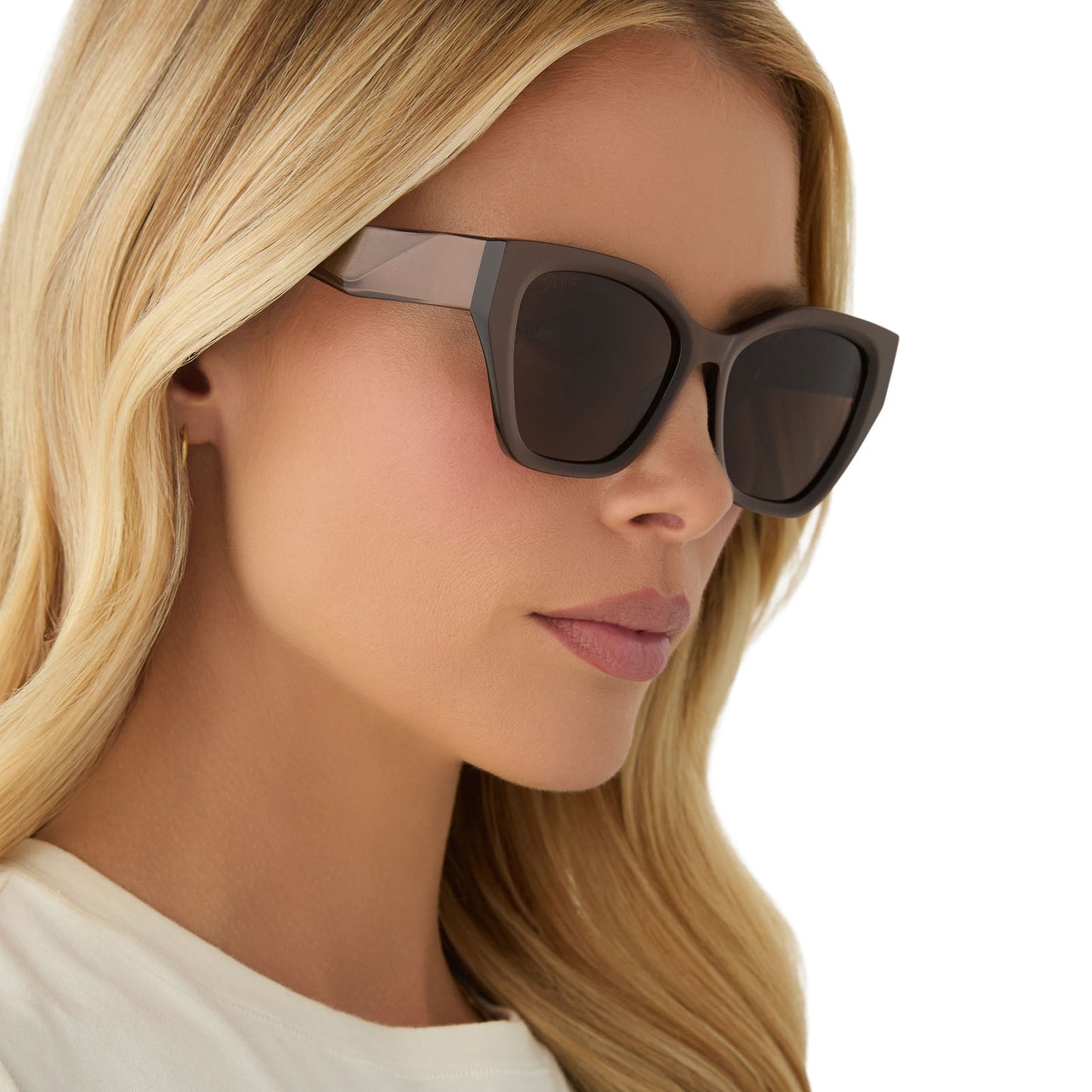 on model - female wearing diff eyewear featuring the evie cat eye sunglasses with a moscow mule frame and brown lenses angled view