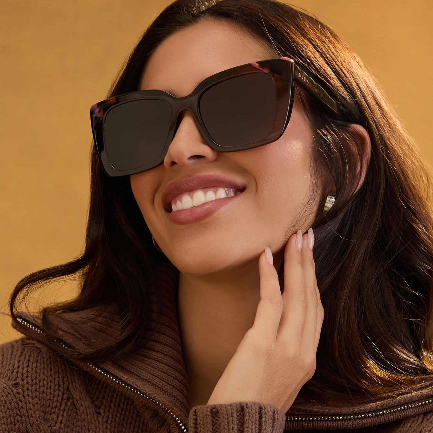 lifestyle - female wearing diff eyewear featuring the lizzy cat eye sunglasses with a whiskey + torino tortoise frame and brown lenses front view