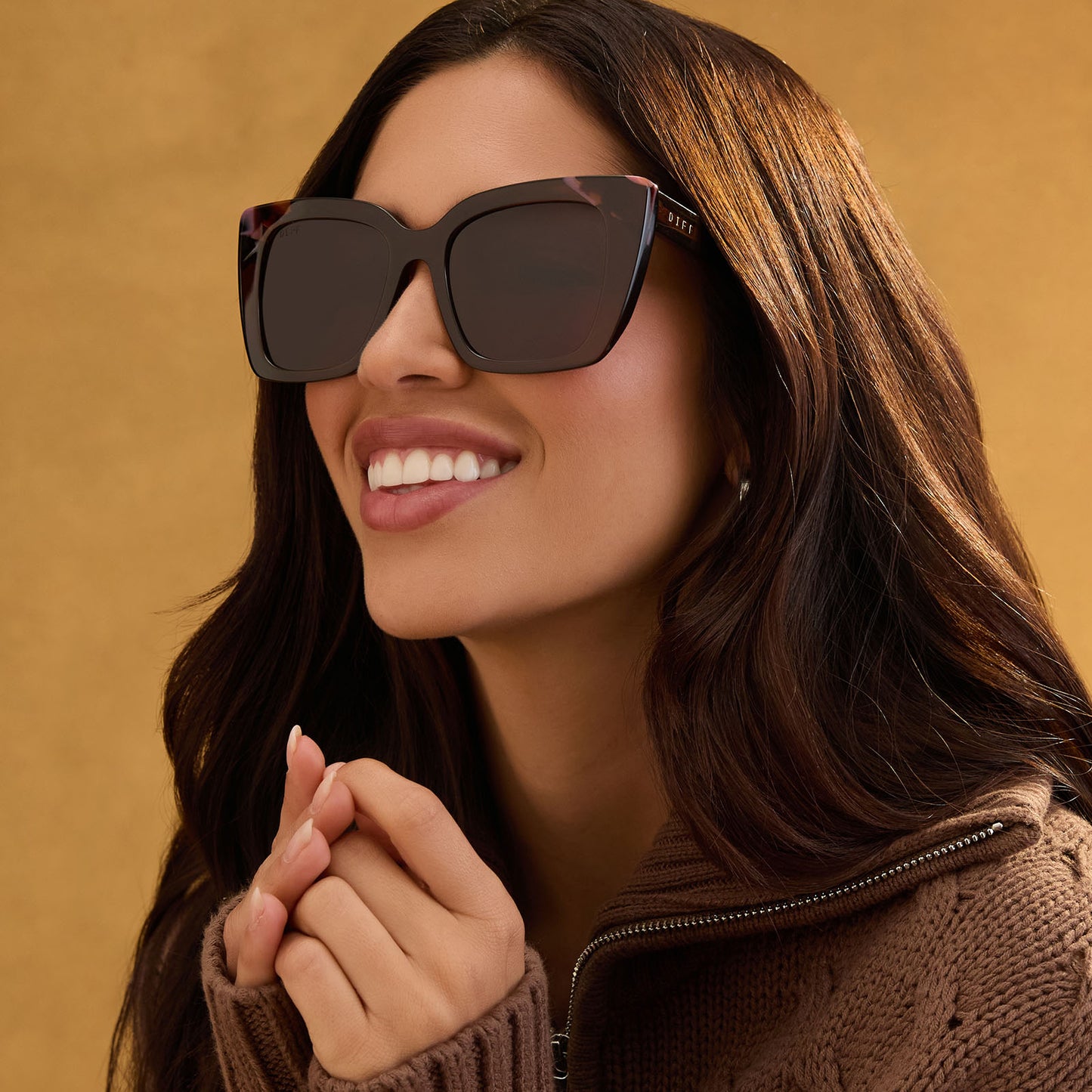 lifestyle - female wearing diff eyewear featuring the lizzy cat eye sunglasses with a whiskey + torino tortoise frame and brown lenses angled view