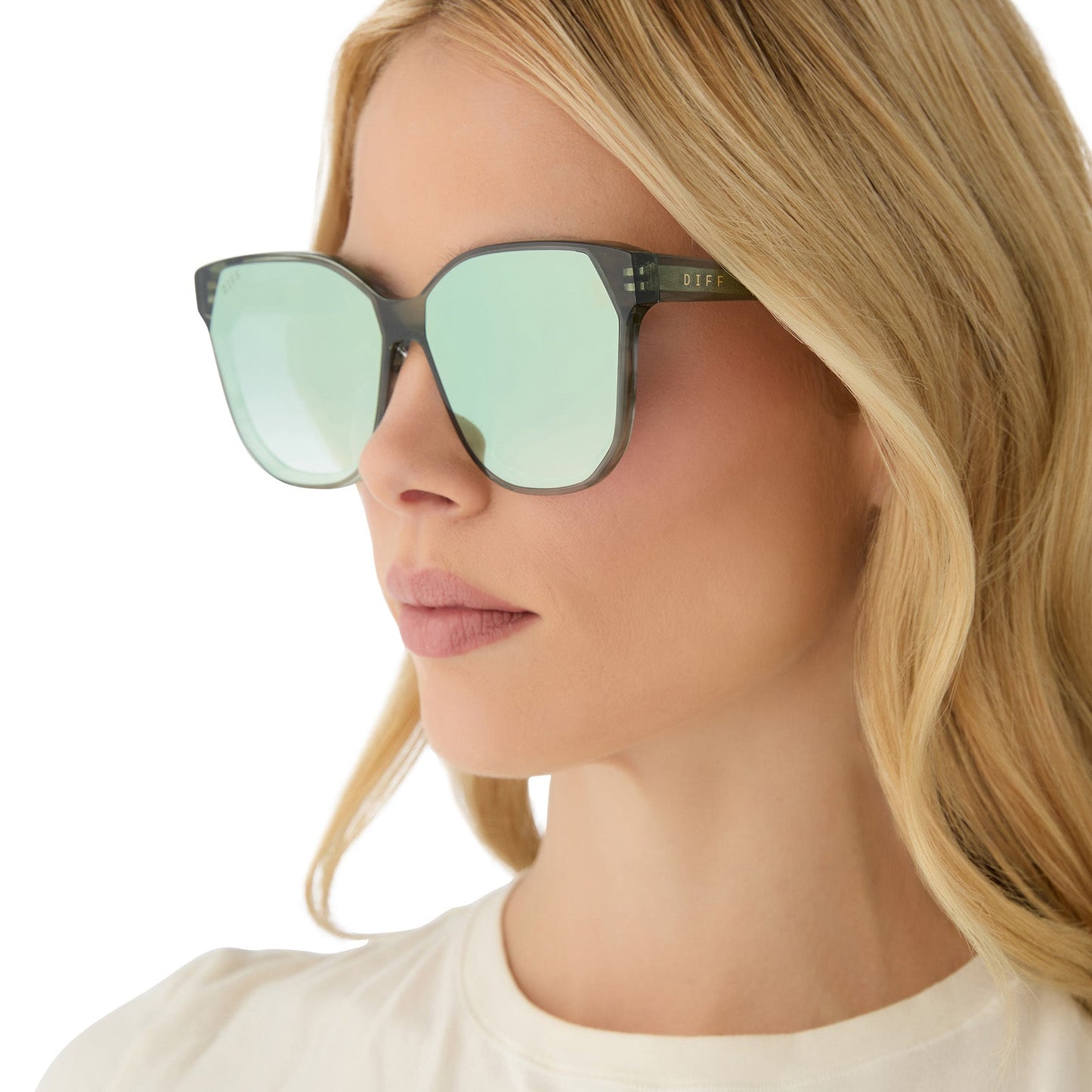 on model - female wearing diff eyewear featuring the gia square sunglasses with a cool matcha green frame and cool matcha mirror lenses angled view