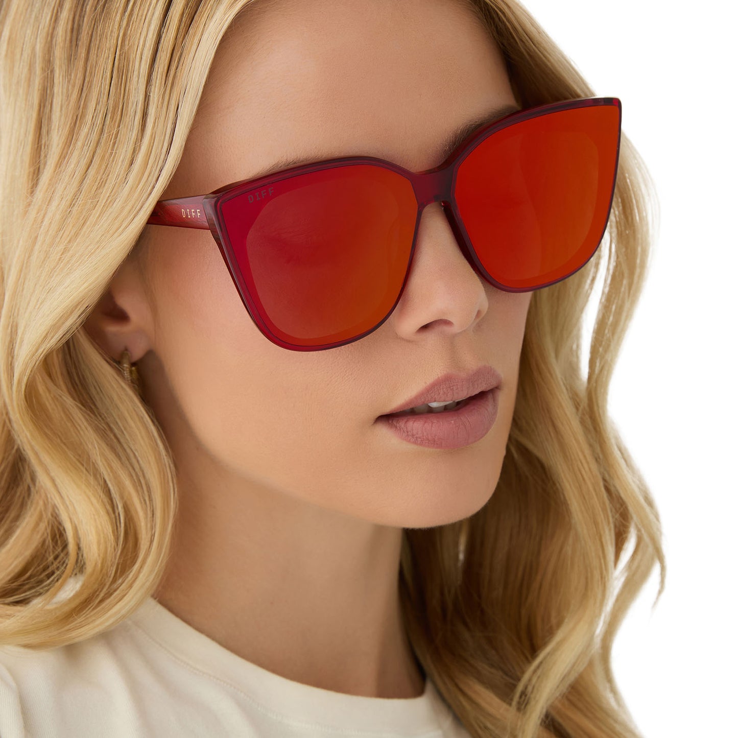 on model - female wearing diff eyewear gjelina cat eye sunglasses with a red hot summer frame and red hot summer mirror lenses angled view