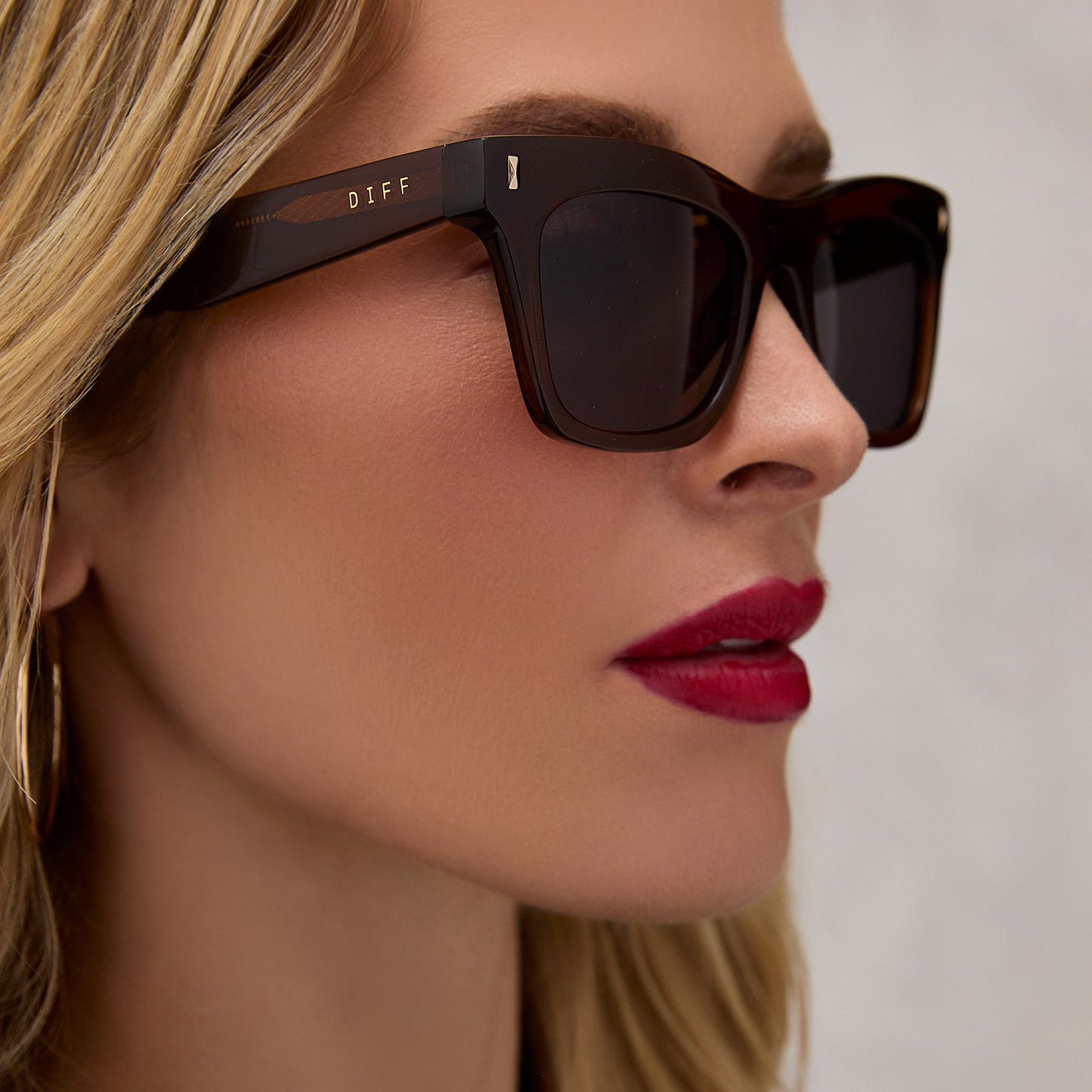 on model - female wearing diff eyewear featuring the bradley cat eye sunglasses with a whiskey brown frame and grey lenses side view