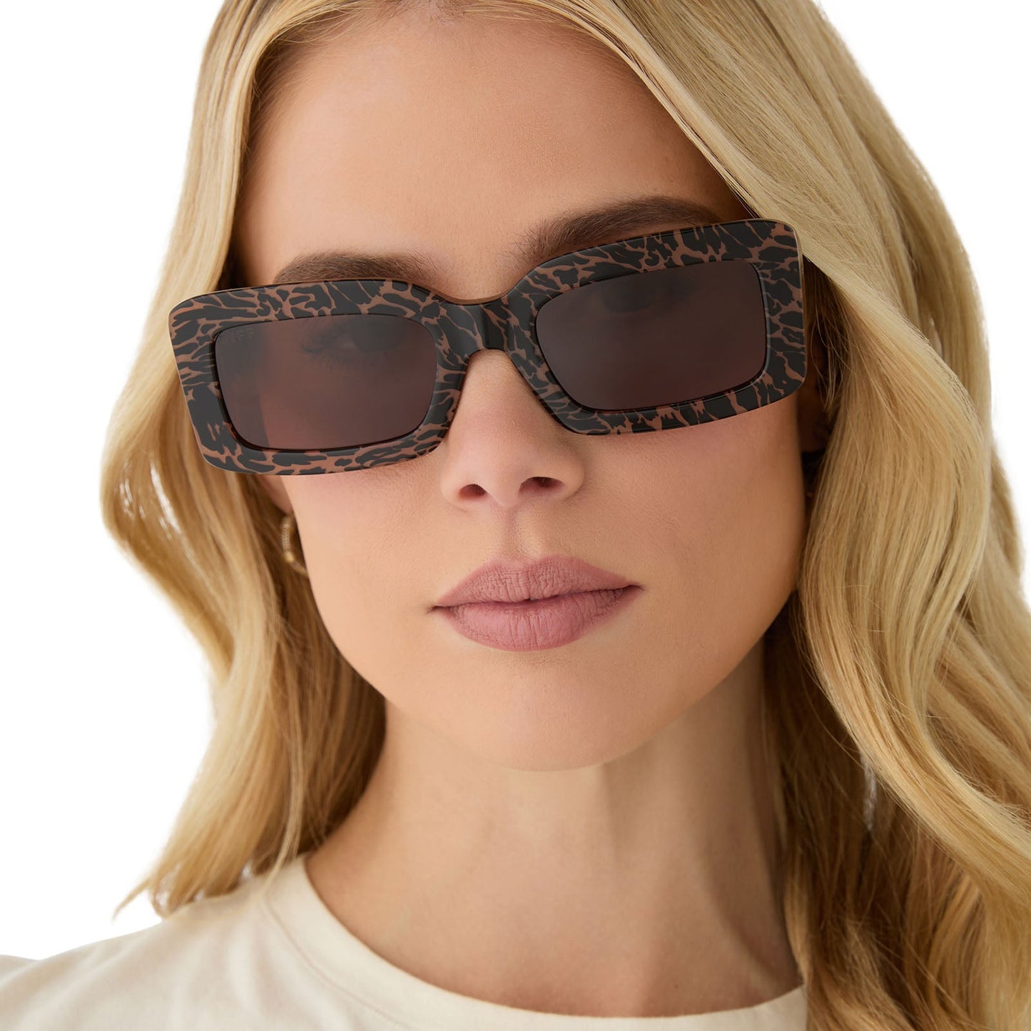 on model - female wearing diff eyewear featuring the indy rectangle sunglasses with a animal print frame and brown lenses front view