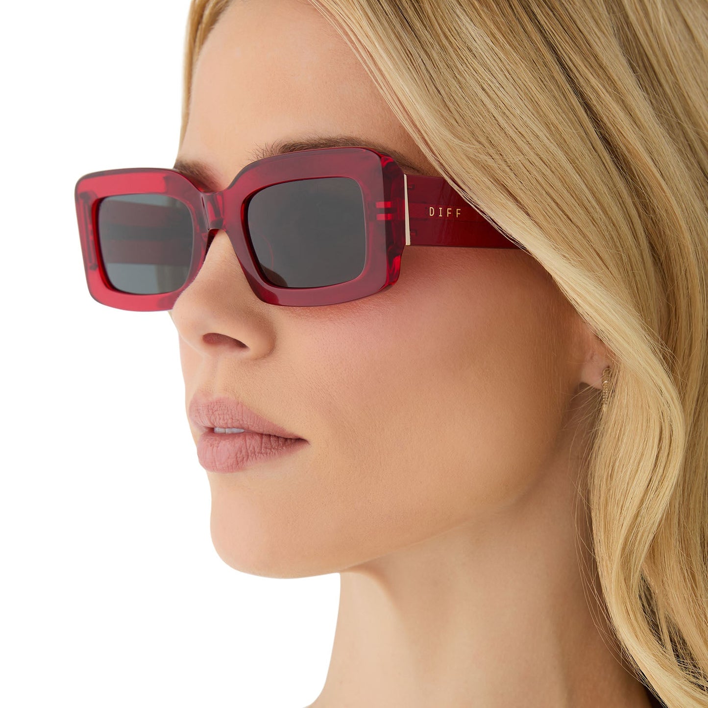 on model - female wearing diff eyewear featuring the indy rectangle sunglasses with a red hot summer frame and grey polarized lenses angled view