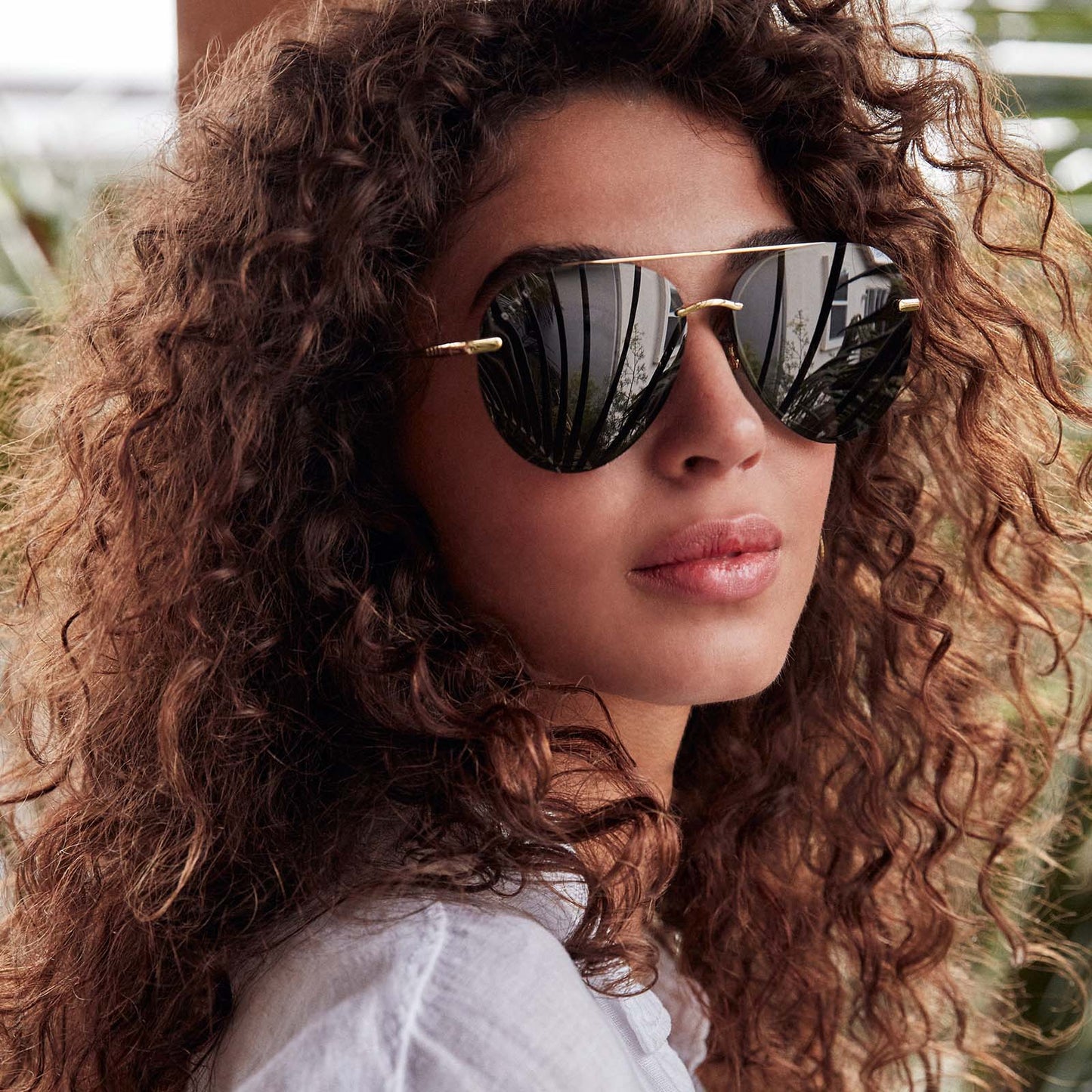 lifestyle - Lenox sunglasses with gold frames and G15 polarized lens on model