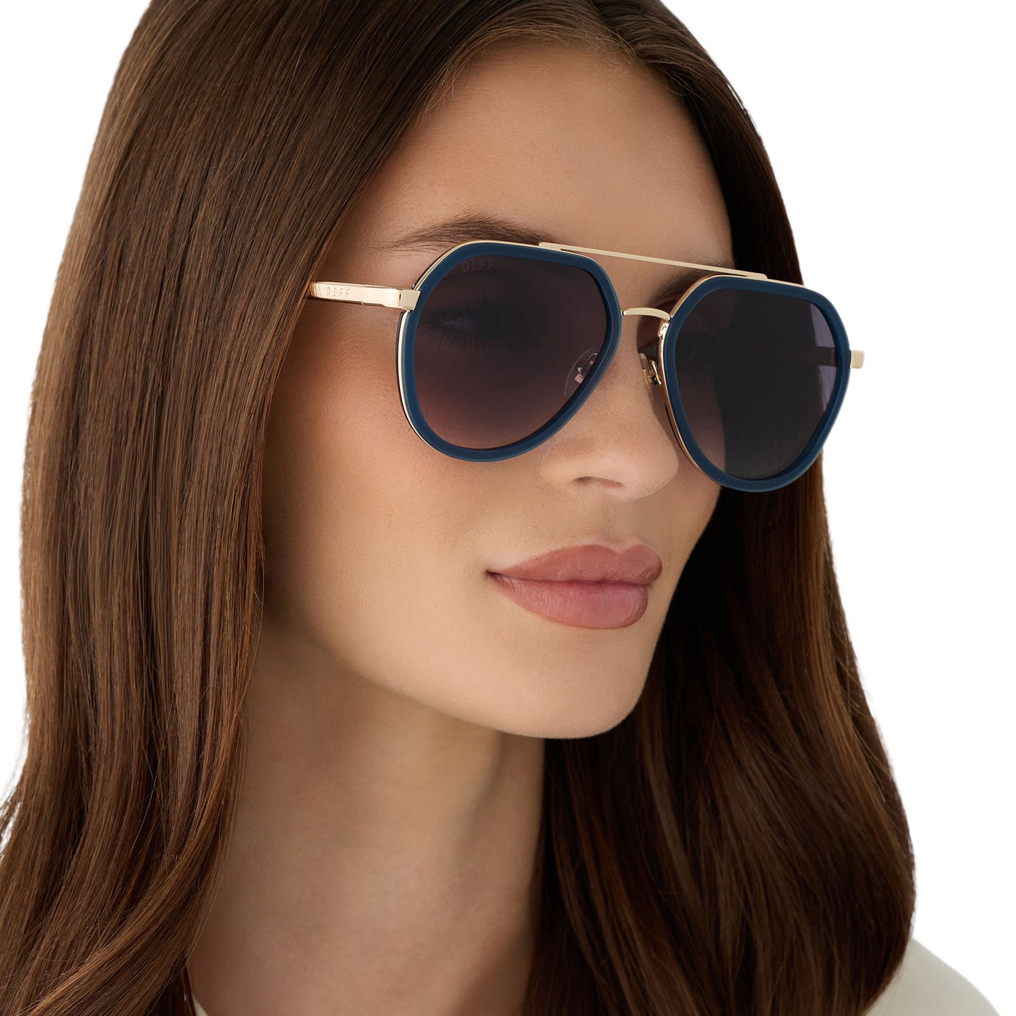 on model - female wearing diff eyewear featuring the joey round sunglasses with a clubhouse blue & brushed gold metal frame with grey gradient lenses angled view