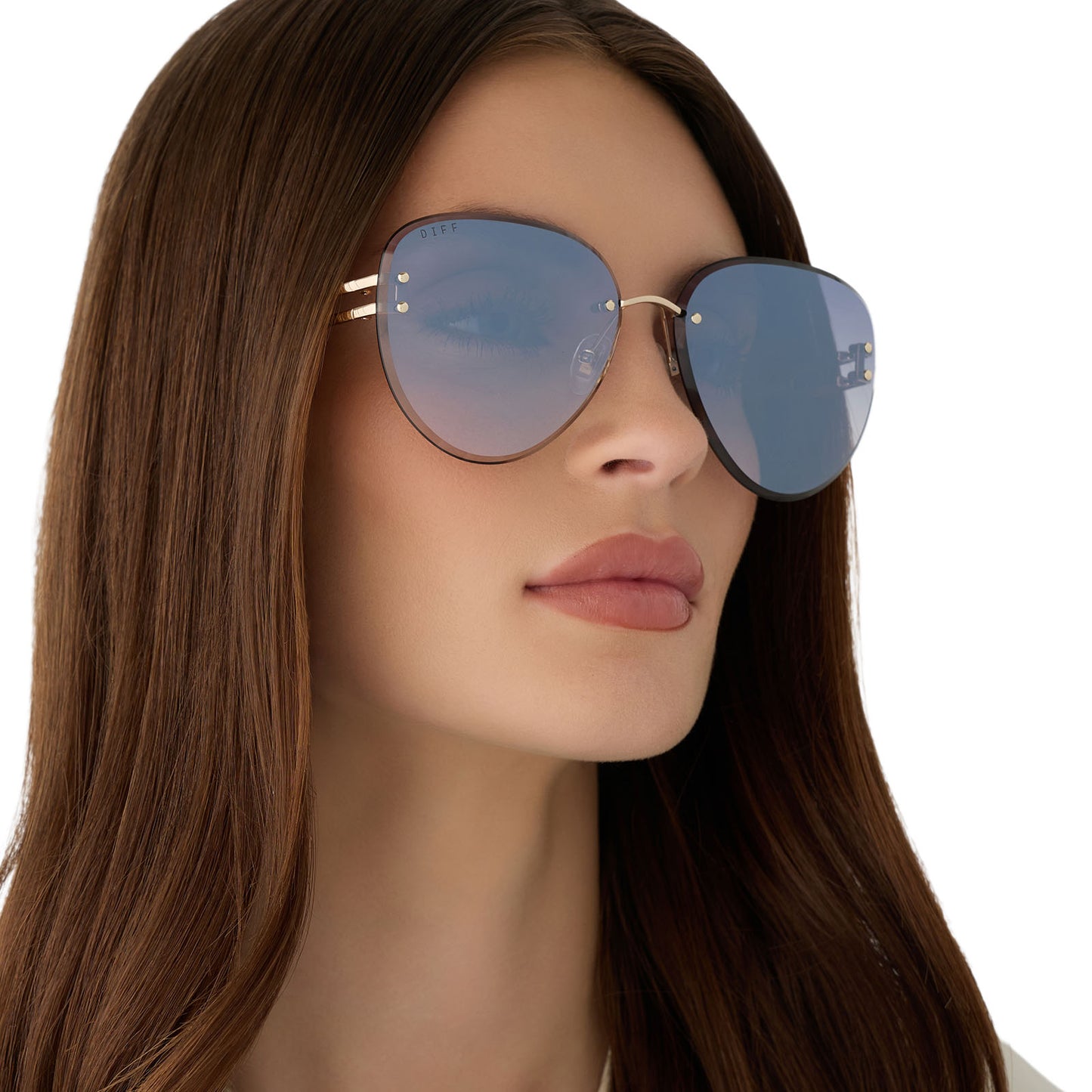 on model - female wearing diff eyewear featuring the trista aviator sunglasses with a gold frame and slate blue gradient flash lenses angled view