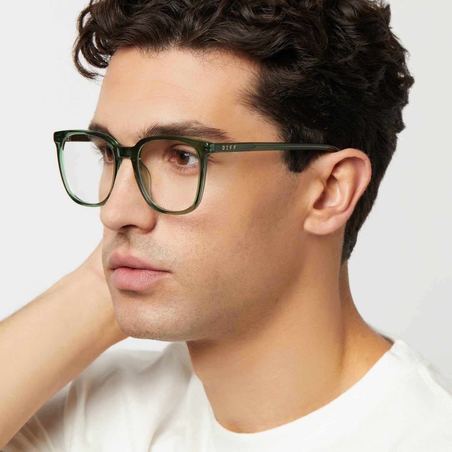 on model - male wearing diff eyewear featuring the parker square prescription glasses with a sage green crystal frame detailed view