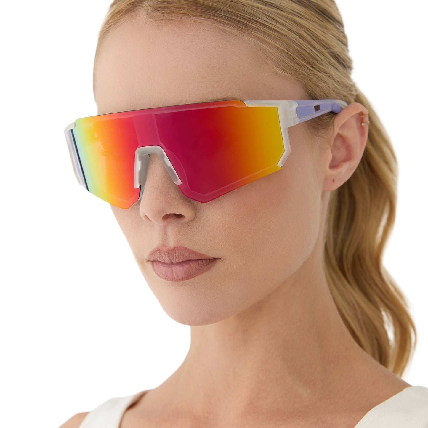 on model - female wearing diff sport featuring the heat shield sunglasses with a crystal clear frame and rainbow mirror polarized lenses angled view