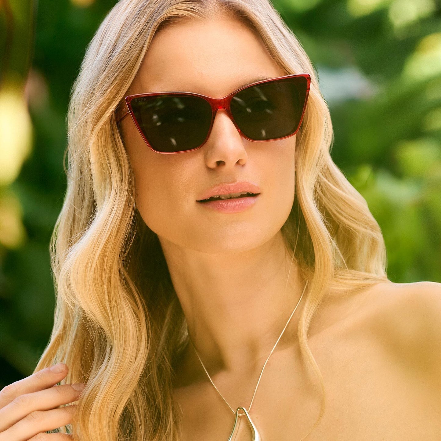 on model - female wearing diff eyewear featuring the alina cat eye sunglasses with a red hot summer frame and grey lenses front view