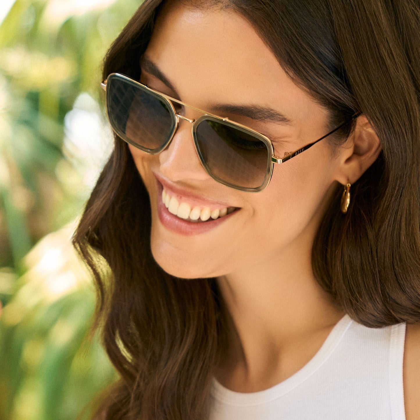 lifesytle - female wearing diff eyewear featuring the jordan navigator sunglasses with a cool matcha green frame and cool matcha gradient lenses detailed view