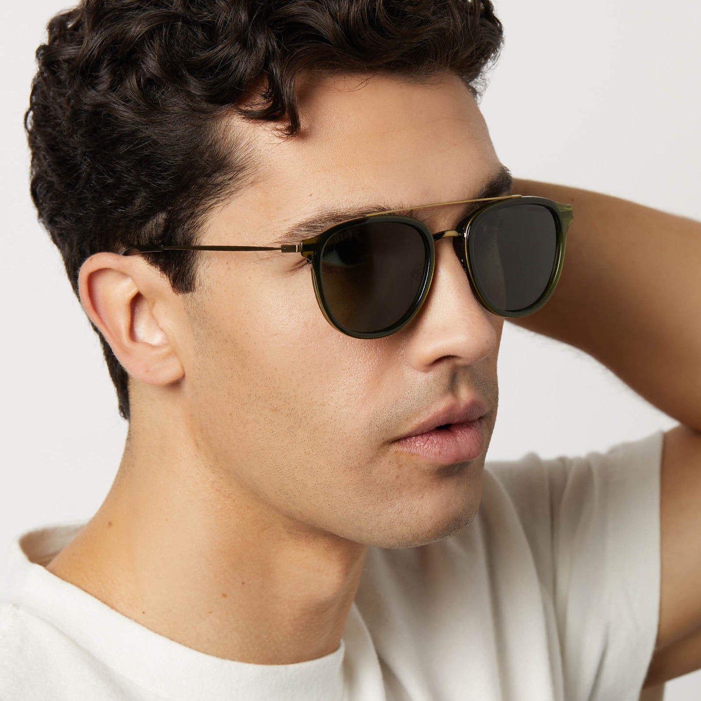 on model - male wearing diff eyewear featuring the camden aviator sunglasses with a dark olive crystal frame and g15 polarized lenses angled view