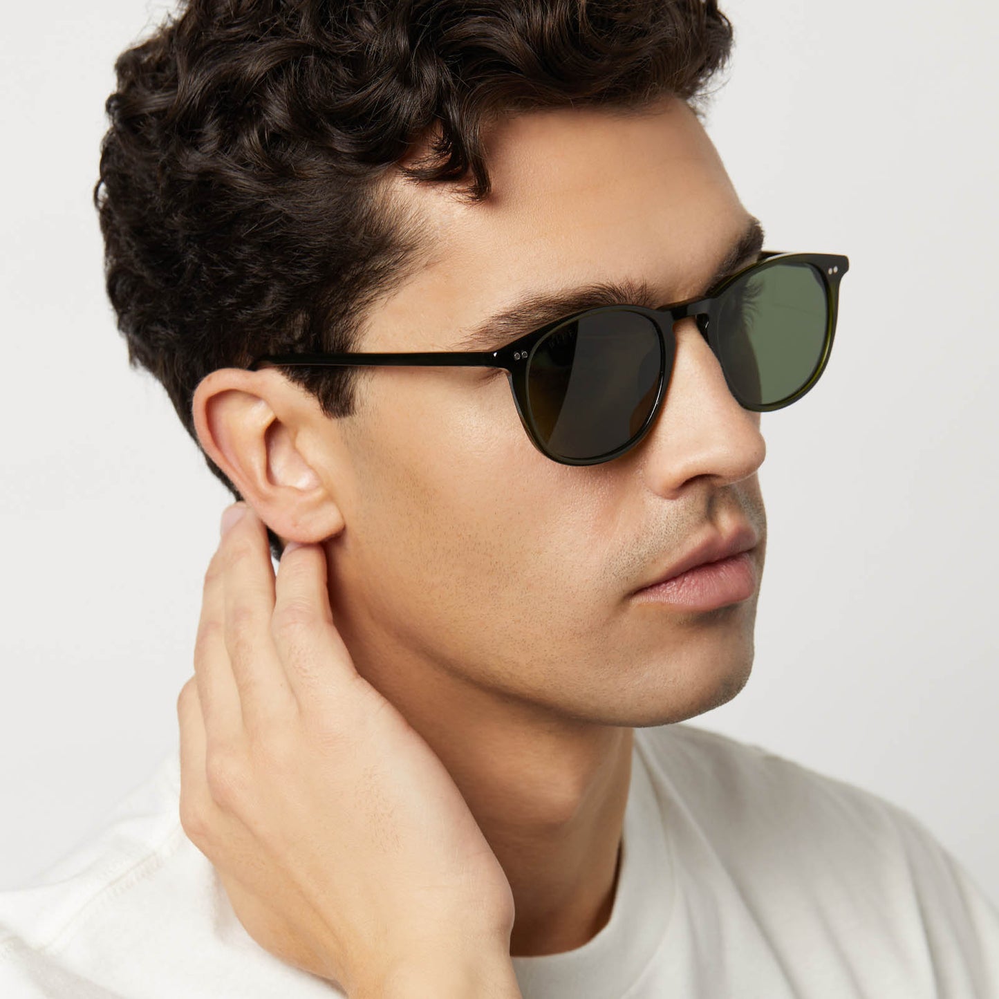 on model - male wearing diff eyewear featuring the jaxson xl square sunglasses with a dark olive crystal frame and g15 polarized lenses angled view