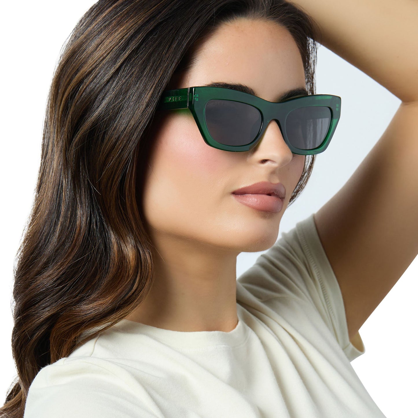 on model - female wearing diff eyewear katarina cat eye sunglasses with a palm green crystal acetate frame and grey lenses angled view