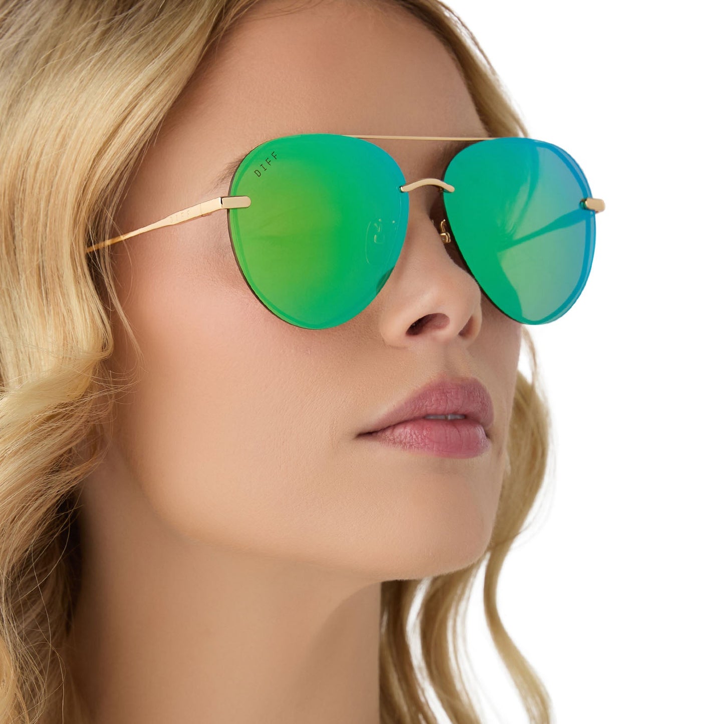 on model - female wearing diff eyewear lenox aviator sunglasses with a gold metal frame, green temple tips and green mirror polarized lenses angled view