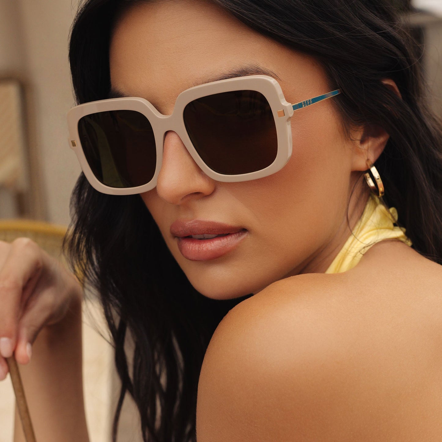 on model - female wearing diff eyewear featuring the sandra square sunglasses with a almond frame and brown gold flash lenses front view