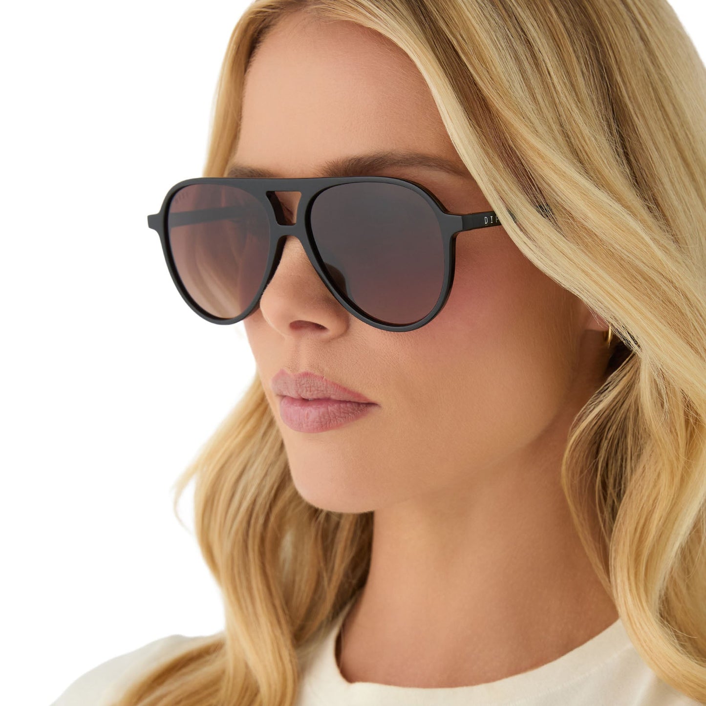 on model - female wearing diff eyewear featuring the tosca ii aviator sunglasses with a black frame and brown gradient lenses angled view