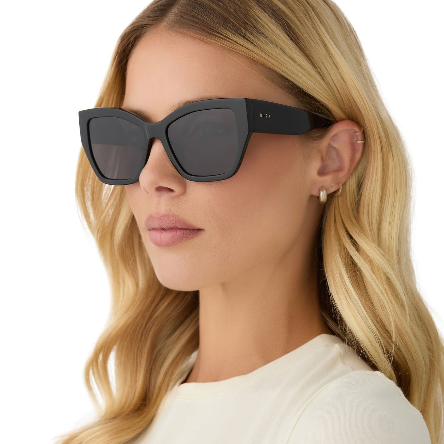 on model - female wearing diff eyewear featuring the vivienne cateye sunglasses with a black frame and grey polarized lenses angled view