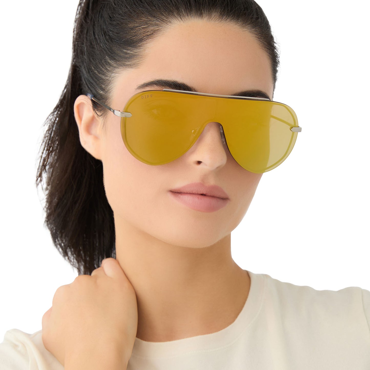 on model - female wearing diff eyewear imani shield sunglasses with a silver frame and gold mirror lenses front view