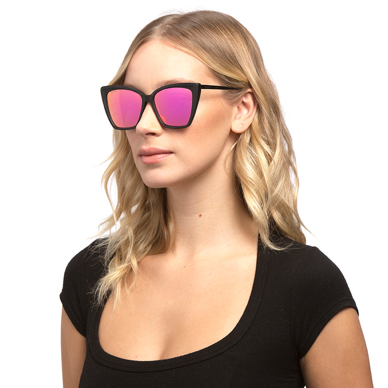 blonde female model wearing becky II matte black pink mirror angle on female
